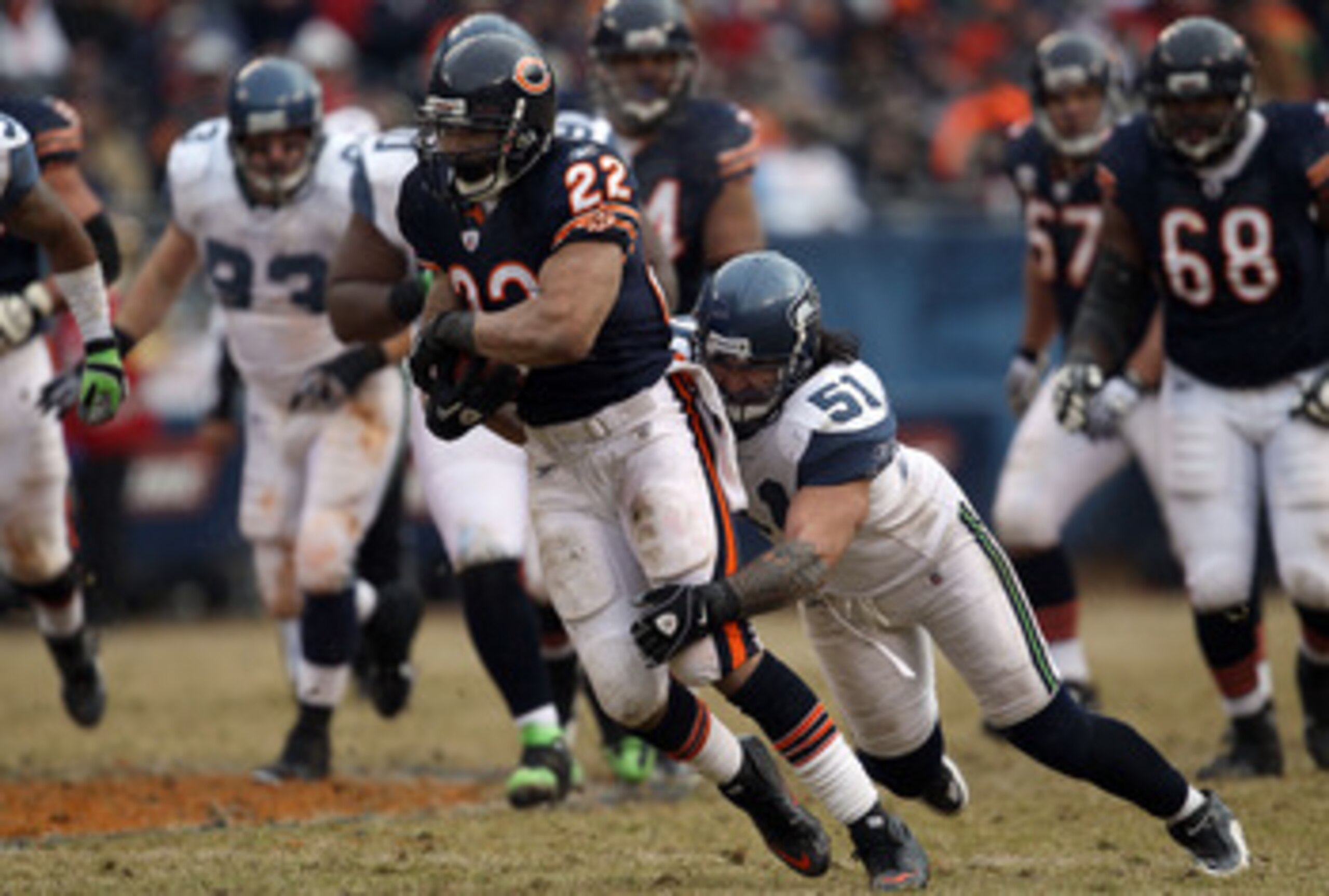 CHICAGO, IL - JANUARY 16: Running back Matt Forte #22 of the Chicago Bears runs the ball as Lofa Tatupu #51 of the Seattle Seahawks attempts to tackle him from behind in the 2011 NFC divisional playoff game at Soldier Field on January 16, 2011 in Chicago CHICAGO, IL - JANUARY 16: Running back Matt Forte #22 of the Chicago Bears runs the ball as Lofa Tatupu #51 of the Seattle Seahawks attempts to tackle him from behind in the 2011 NFC divisional playoff game at Soldier Field on January 16, 2011 in Chicago