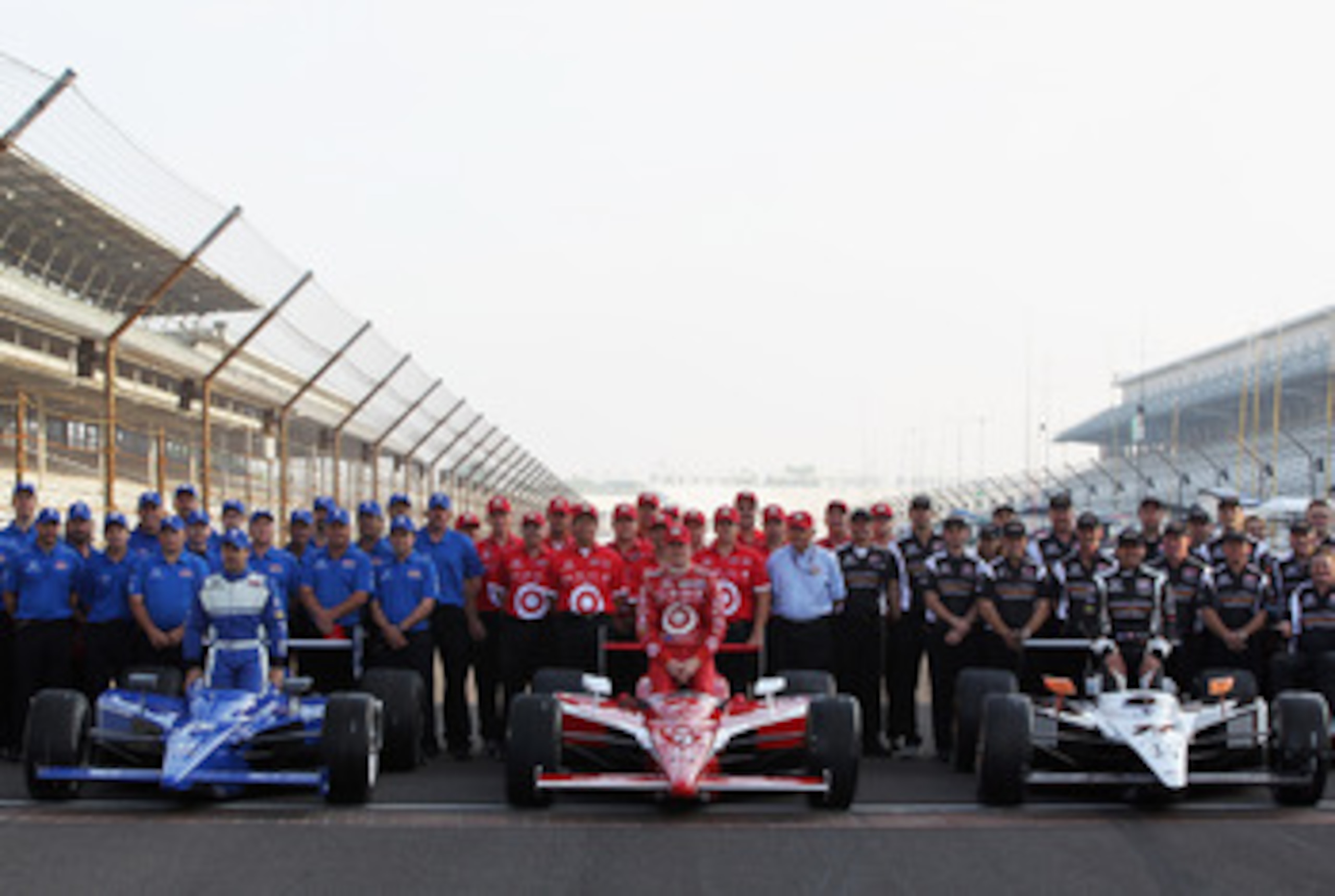 INDIANAPOLIS, IN - MAY 22:  Polesitter Alex Tagliani of Canada, driver of the #77 Bowers & Wilkins/Sam Schmidt Motorsports Dallara Honda, poses on the finish line alongside Scott Dixon of New Zealand, driver of the #9 Target Chip Ganassi Racing Dallara Ho