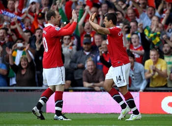 MANCHESTER, ENGLAND - MAY 08:  Javier Hernandez of Manchester United celebrates scoring the opening goal with team mate Wayne Rooney (L) during the Barclays Premier League match between Manchester United and Chelsea at Old Trafford on May 8, 2011 in Manch