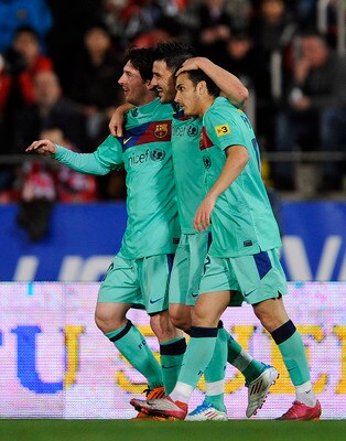 MALLORCA, SPAIN - FEBRUARY 26:  David Villa of FC Barcelona (C) celebrates with his team-mates Lionel Messi (L) and Pedro Rodriguez after scoring his second team's goal under a challenge of Dudu Aouate of Mallorca during the La Liga match between Mallorca