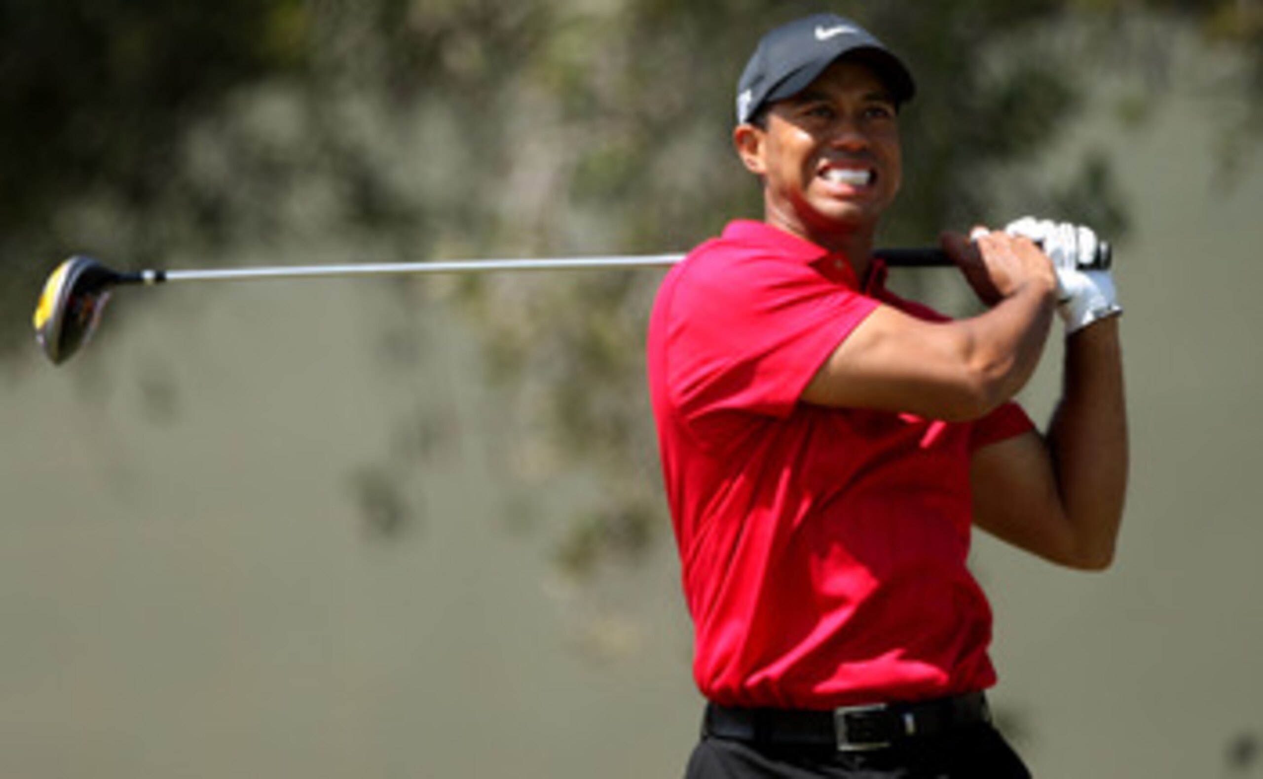 SAN DIEGO - JUNE 15:  Tiger Woods winces from pain due to his knee injury as he hits his tee shot on the seventh tee during the final round of the 108th U.S. Open at the Torrey Pines Golf Course (South Course) on June 15, 2008 in San Diego, California.  (