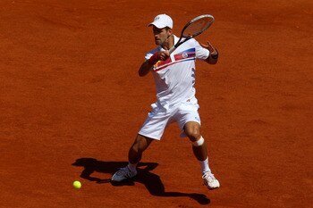 PARIS, FRANCE - MAY 23:  Novak Djokovic of Serbia hits a forehand during the men's singles first round match between Thiemo De Bakker of Netherlands and Novak Djokovic of Serbia on day two of the French Open at Roland Garros on May 23, 2011 in Paris, Fran