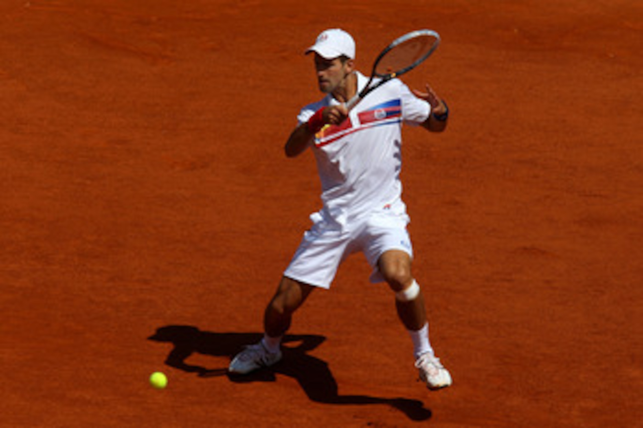 PARIS, FRANCE - MAY 23:  Novak Djokovic of Serbia hits a forehand during the men's singles first round match between Thiemo De Bakker of Netherlands and Novak Djokovic of Serbia on day two of the French Open at Roland Garros on May 23, 2011 in Paris, Fran
