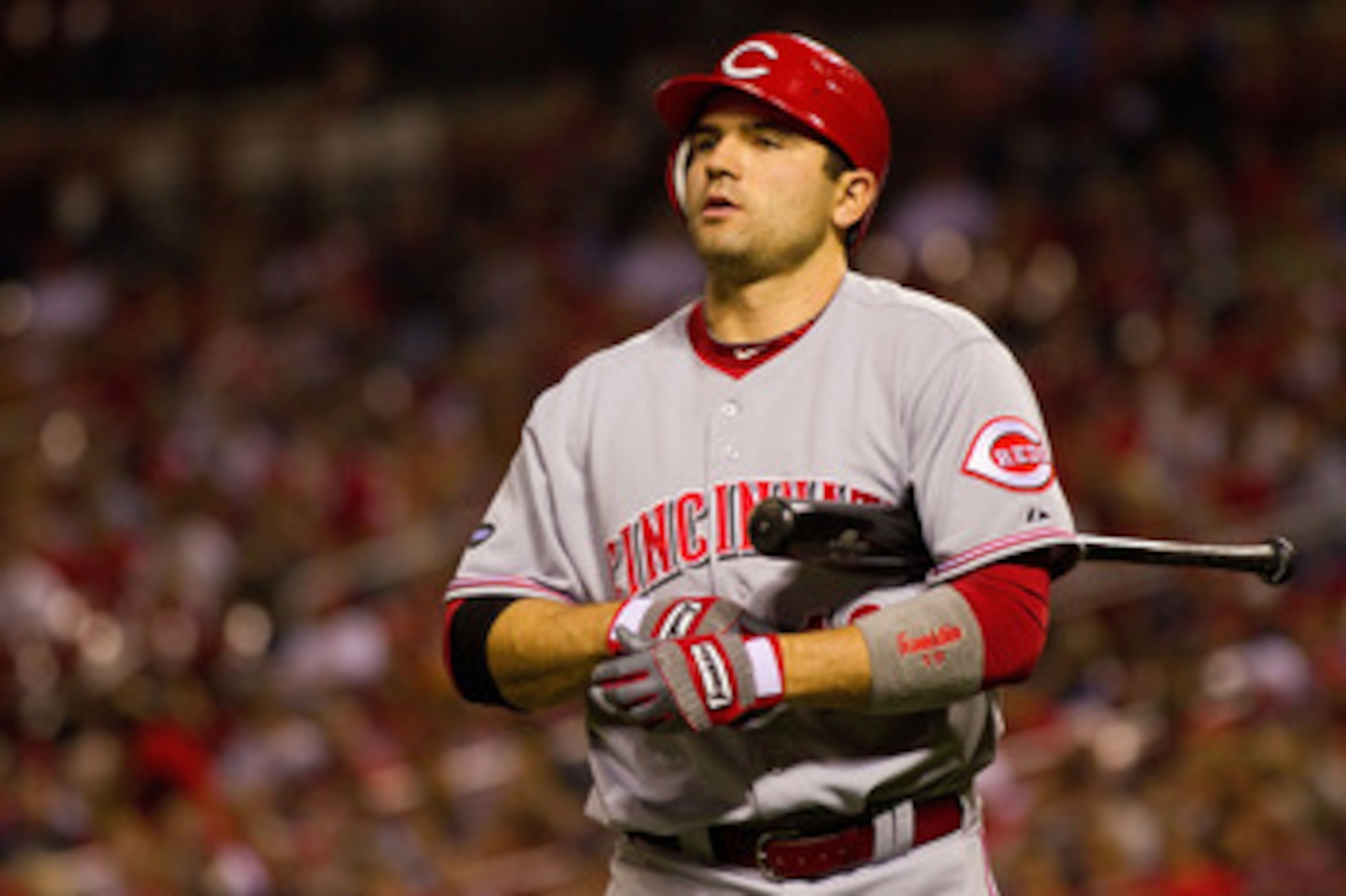 ST. LOUIS, MO - APRIL 22: Joey Votto #19 of the Cincinnati Reds returns to the dugout after striking out against the St. Louis Cardinals at Busch Stadium on April 22, 2011 in St. Louis, Missouri.  (Photo by Dilip Vishwanat/Getty Images)