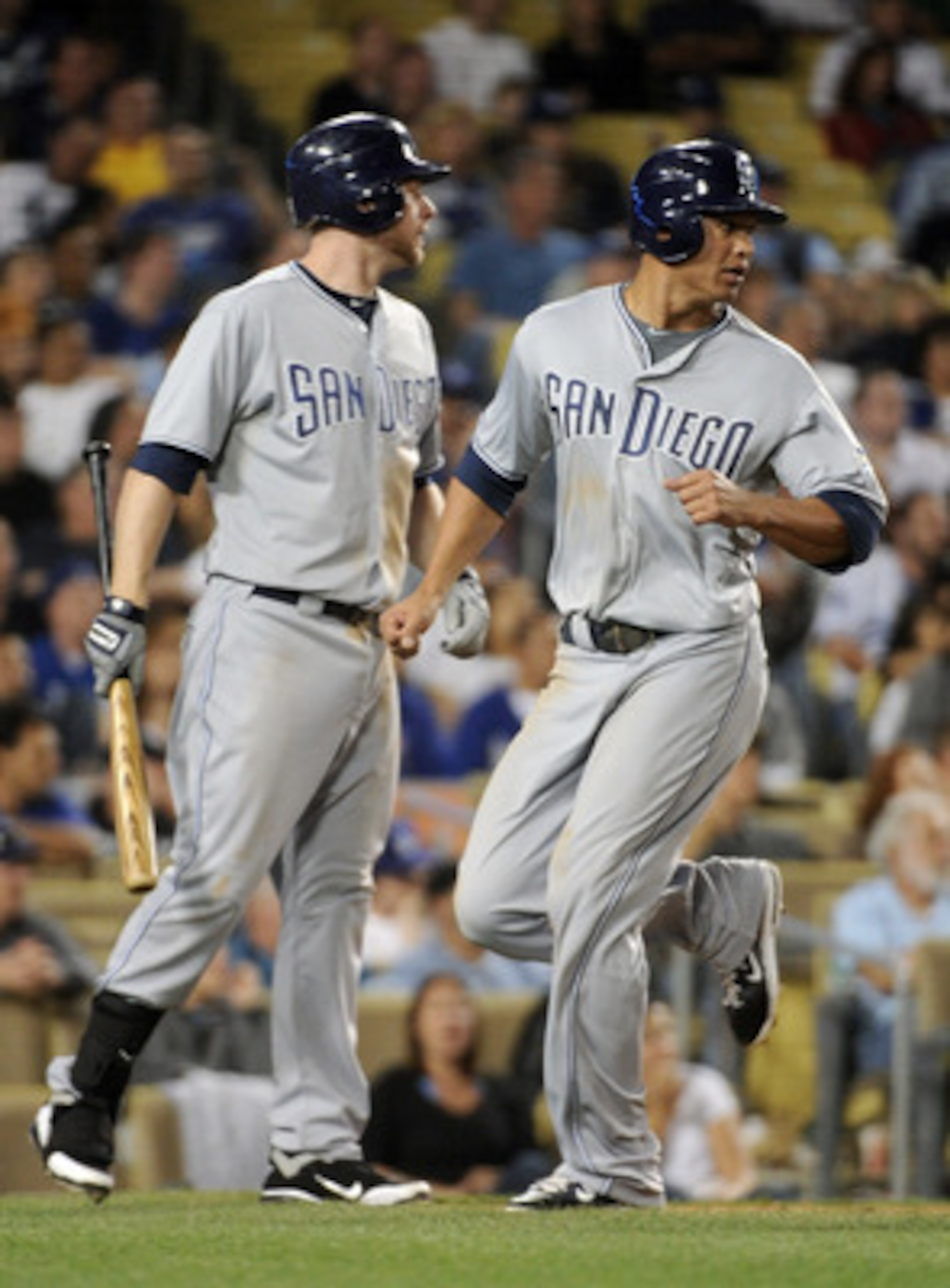 LOS ANGELES, CA - APRIL 30:  Will Venable #25 of the San Diego Padres scores a run for a 2-1 lead as he and Chase Headley #7 look back to third base where teammate Jason Bartlett #8 is thrown out during the fifth inning at Dodger Stadium on April 30, 2011