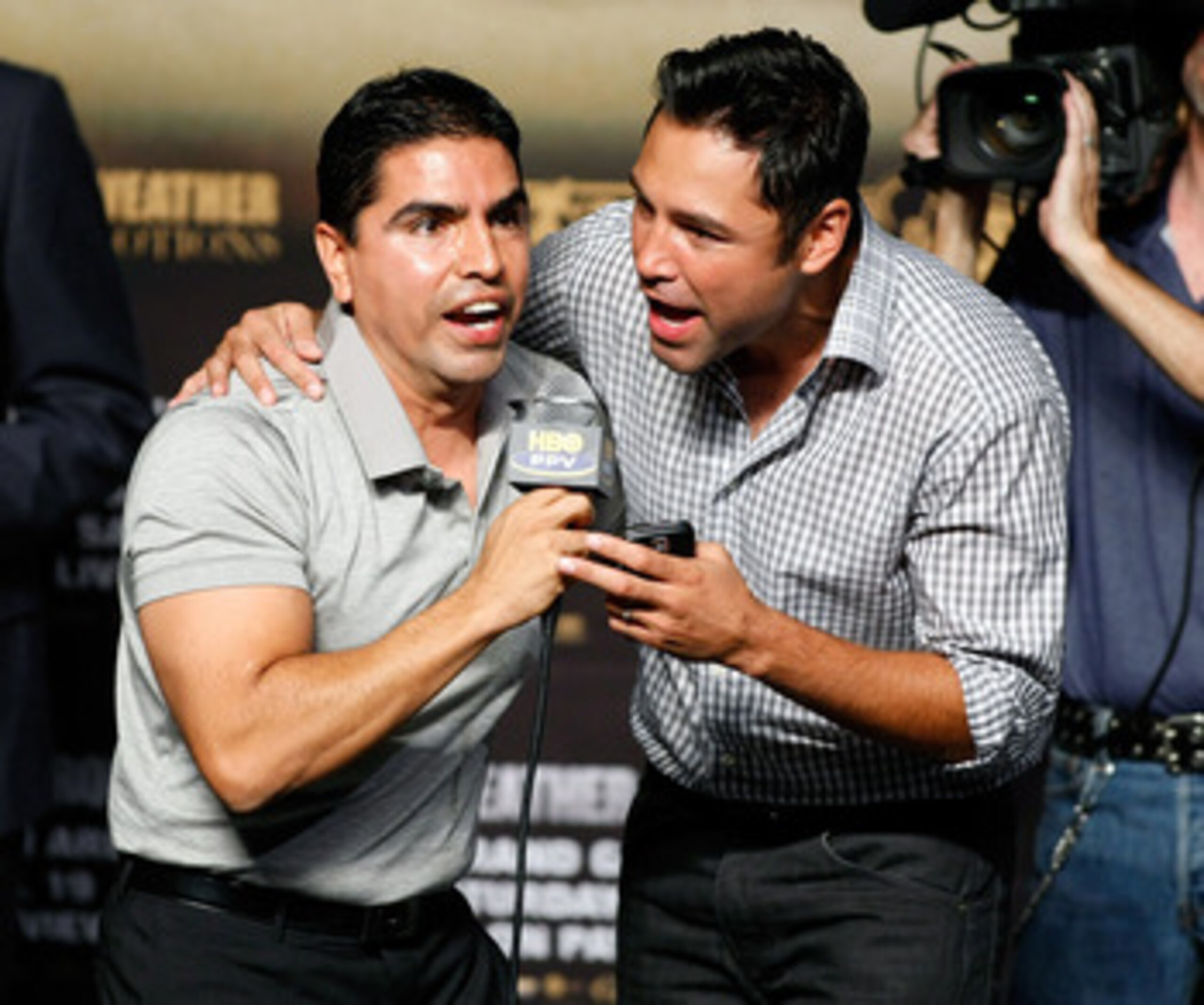 LAS VEGAS - SEPTEMBER 18:  Radio personality Eddie 'Piolin' Sotelo (L) and boxing promoter Oscar De La Hoya entertain the crowd during the official weigh-in for boxers Floyd Mayweather Jr. and Juan Manuel Marquez at the MGM Grand Garden Arena September 18