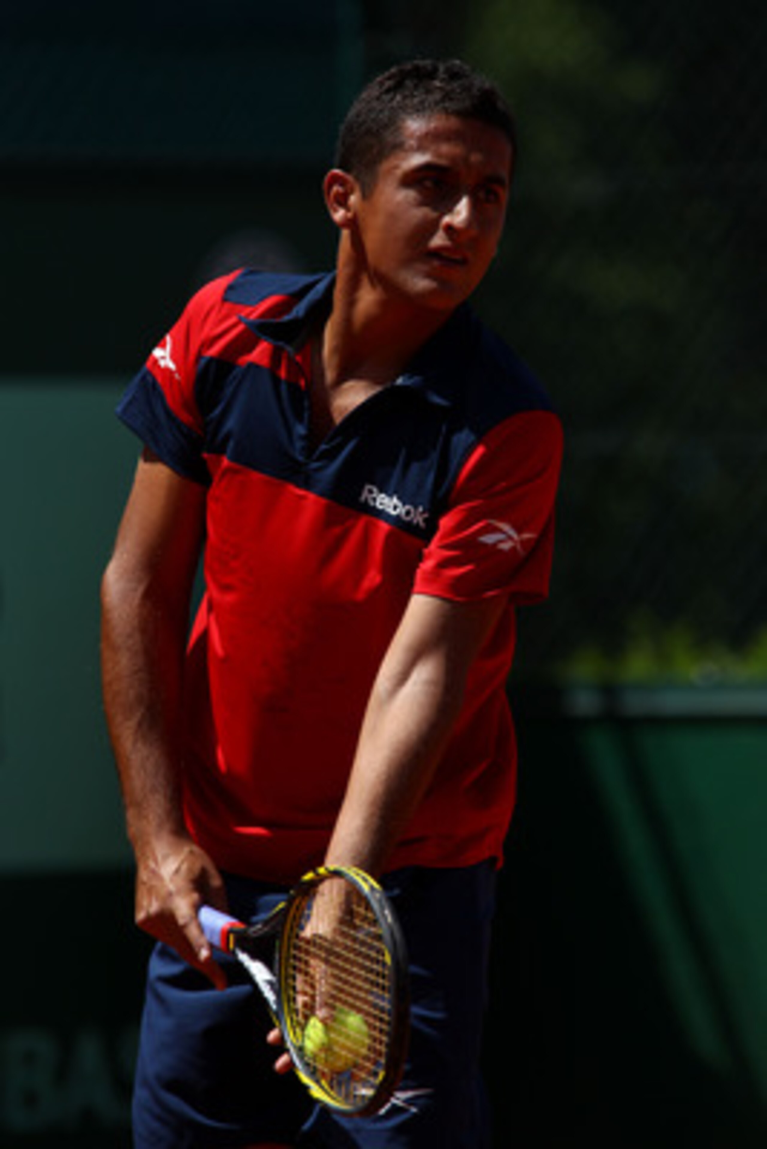 PARIS, FRANCE - MAY 24:  Nicolas Almagro of Spain serves during the men's singles round one match between Nicolas Almagro of Spain and Lukasz Kubot of Poland on day three of the French Open at Roland Garros on May 24, 2011 in Paris, France.  (Photo by Ale
