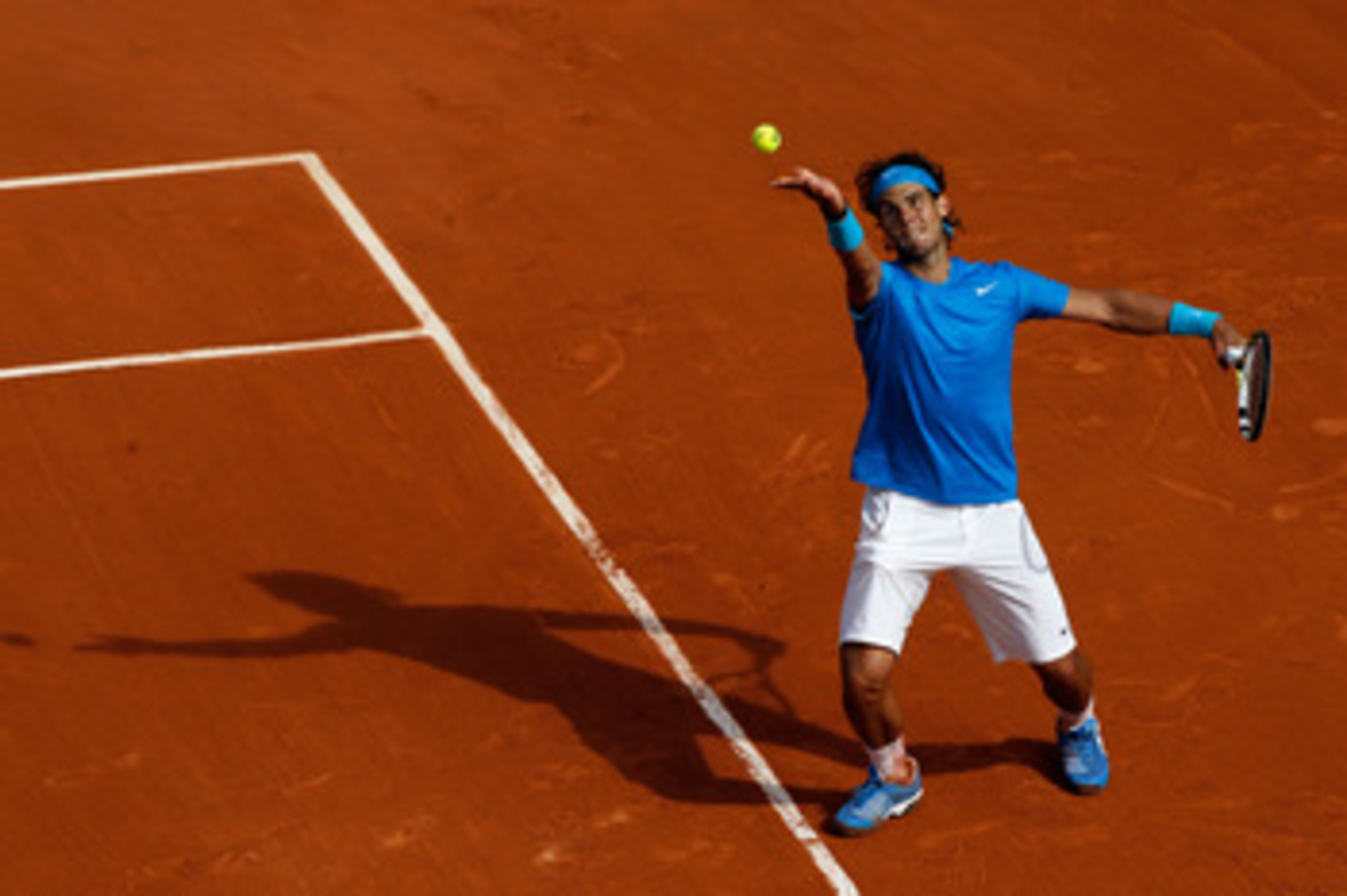 PARIS, FRANCE - MAY 24:  Rafael Nadal of Spain serves during the men's singles round one match between Rafael Nadal of Spain and John Isner of USA on day three of the French Open at Roland Garros on May 24, 2011 in Paris, France.  (Photo by Matthew Stockm