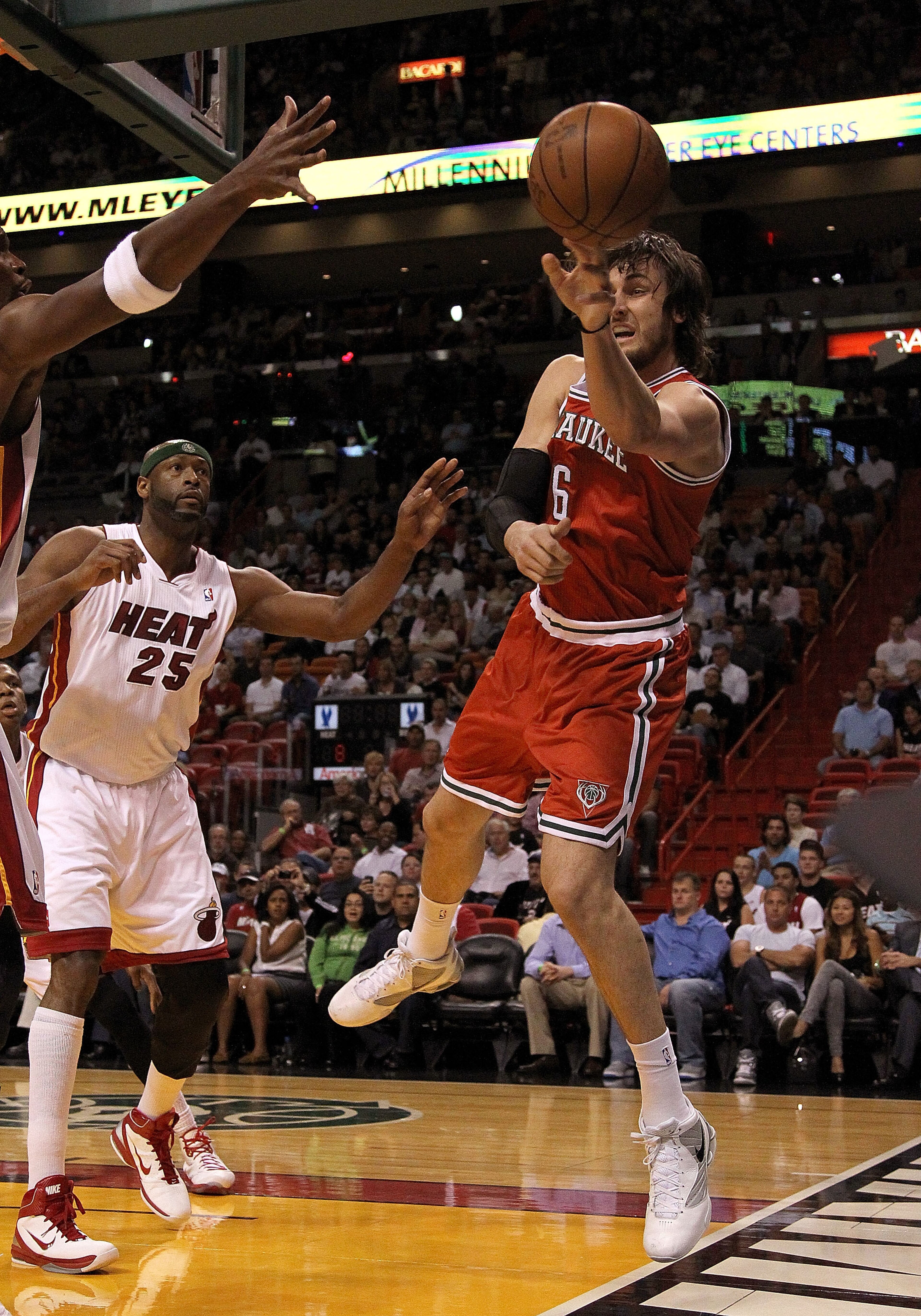 MIAMI, FL - APRIL 06:  Andrew Bogut #6 of the Milwaukee Bucks passes away from  Eric Dampier #25 of the Miami Heat during a game at American Airlines Arena on April 6, 2011 in Miami, Florida. NOTE TO USER: User expressly acknowledges and agrees that, by d