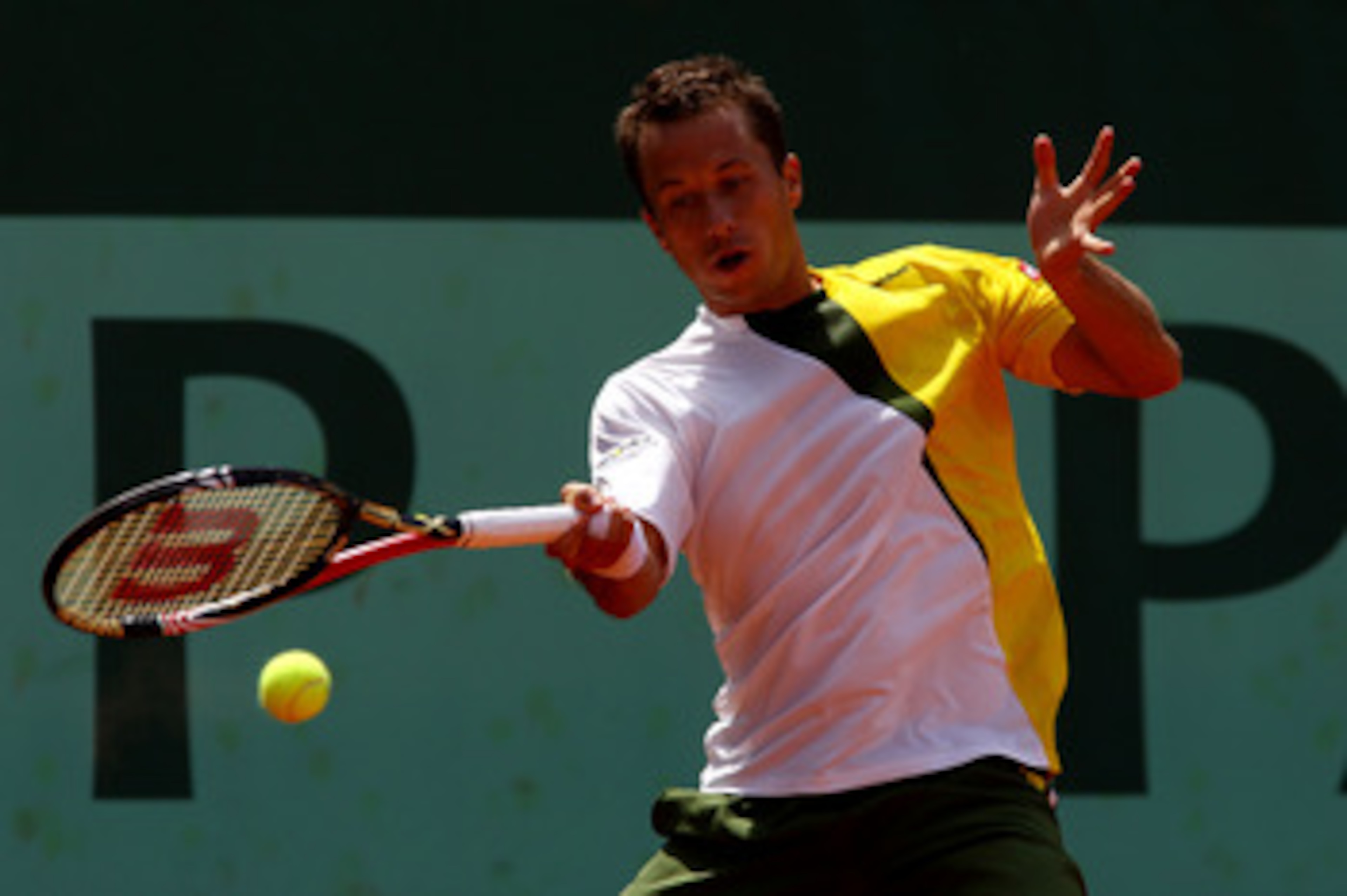 PARIS, FRANCE - MAY 24:  Philipp Kohlschreiber of Germany plays a forehand during the men's singles round one match between Sam Querrey of USA and Philipp Kohlschreiber of Germany on day three of the French Open at Roland Garros on May 24, 2011 in Paris, 