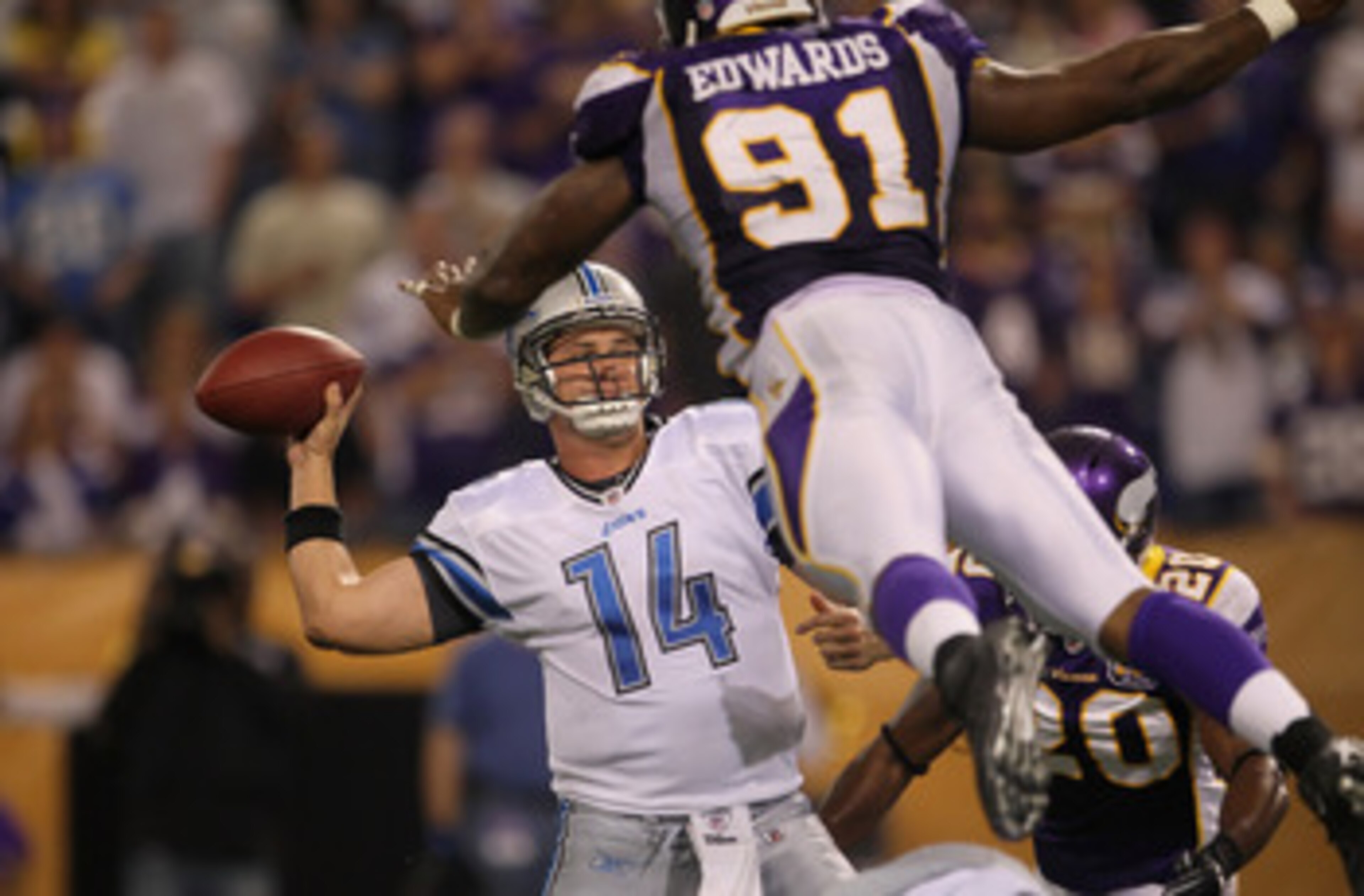 MINNEAPOLIS - SEPTEMBER 26: Quarterback Shaun Hill #14 of the Detroit Lions is pressured by Ray Edwards #91 of the Minnesota Vikings during the second half at Hubert H. Humphrey Metrodome on September 26, 2010 in Minneapolis, Minnesota. The Vikings defe MINNEAPOLIS - SEPTEMBER 26: Quarterback Shaun Hill #14 of the Detroit Lions is pressured by Ray Edwards #91 of the Minnesota Vikings during the second half at Hubert H. Humphrey Metrodome on September 26, 2010 in Minneapolis, Minnesota. The Vikings defe