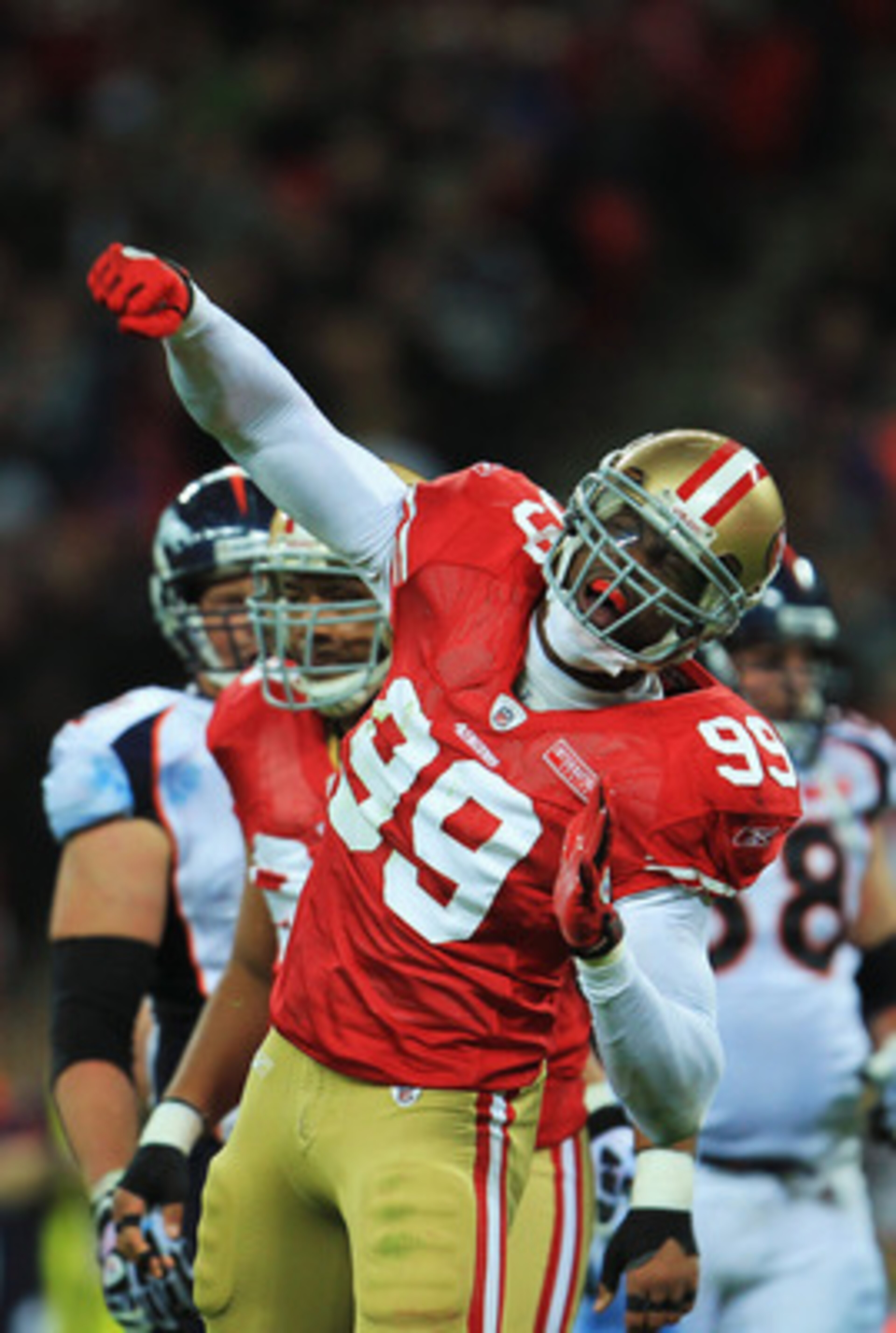LONDON, ENGLAND - OCTOBER 31: Manny Lawson #99 of San Francisco 49ers celebrates as he sacks Kyle Orton #8 of Denver Broncos during the NFL International Series match between Denver Broncos and San Francisco 49ers at Wembley Stadium on October 31, 2010 i LONDON, ENGLAND - OCTOBER 31: Manny Lawson #99 of San Francisco 49ers celebrates as he sacks Kyle Orton #8 of Denver Broncos during the NFL International Series match between Denver Broncos and San Francisco 49ers at Wembley Stadium on October 31, 2010 i