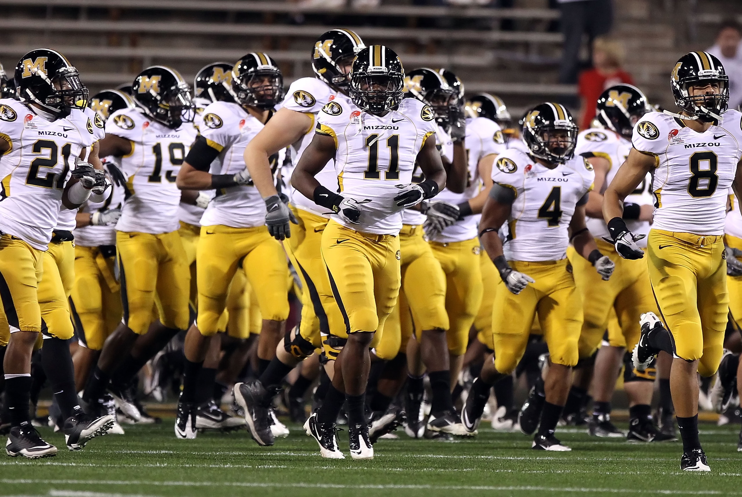 TEMPE, AZ - DECEMBER 28:  Jarrell Harrison #11 (C) of the Missouri Tigers runs onto the field with teammates before the Insight Bowl against the Iowa Hawkeyes at Sun Devil Stadium on December 28, 2010 in Tempe, Arizona.  (Photo by Christian Petersen/Getty