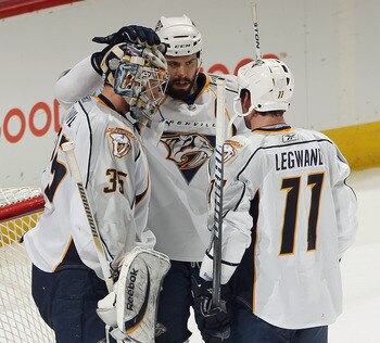 DENVER, CO - MARCH 31:  Goalie Pekka Rinne #35 of the Nashville Predators is congratulated by teammates Shea Weber #6 and David Legwand #11 after their victory over the Colorado Avalanche at the Pepsi Center on March 31, 2011 in Denver, Colorado. Rinne ha