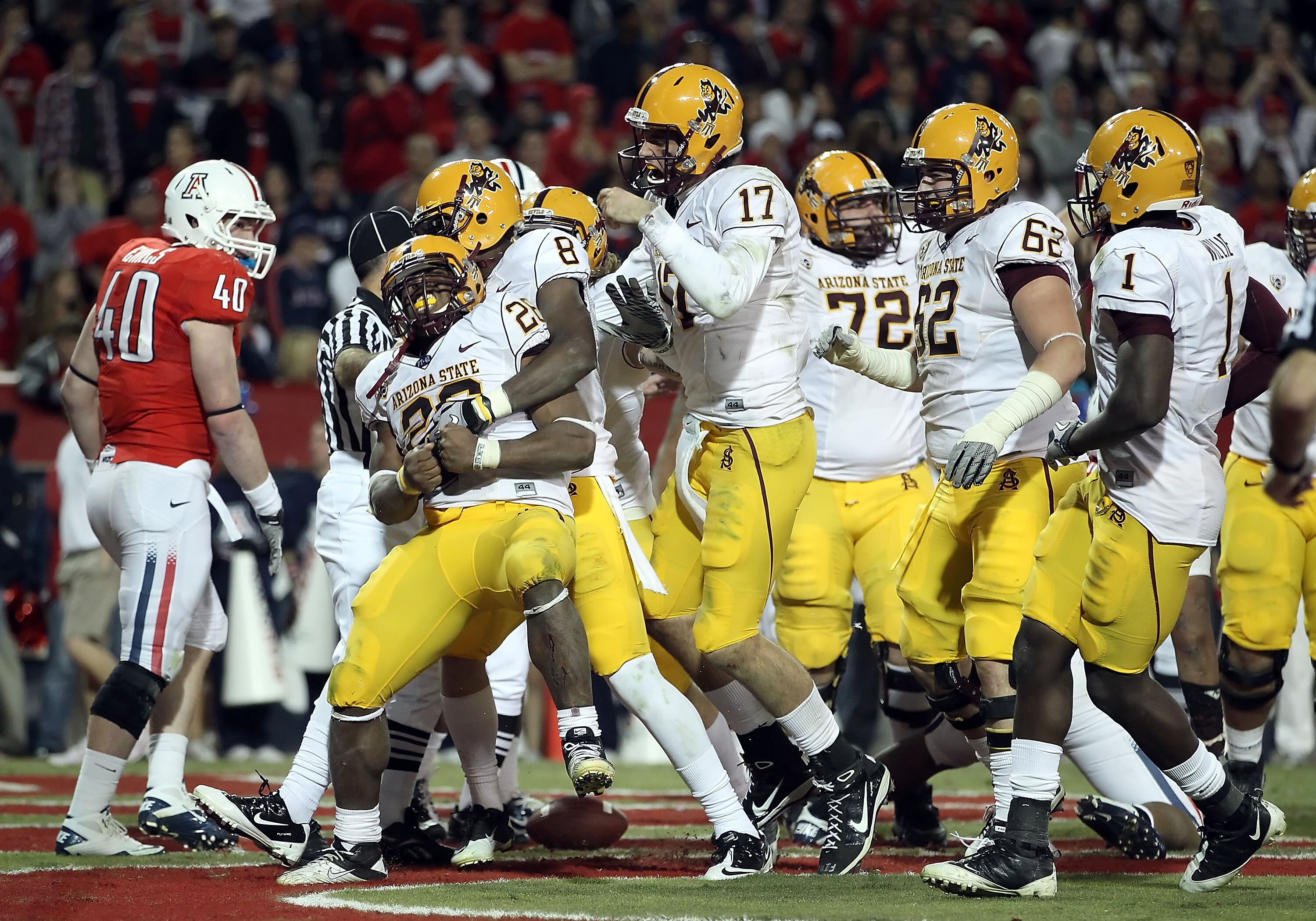 TUCSON, AZ - DECEMBER 02:  Quarterback Brock Osweiler #17 of the Arizona State Sun Devils celebrates with Cameron Marshall #26 after he scored a rushing touchdown against the Arizona Wildcats during the double overtime of the college football game at Ariz