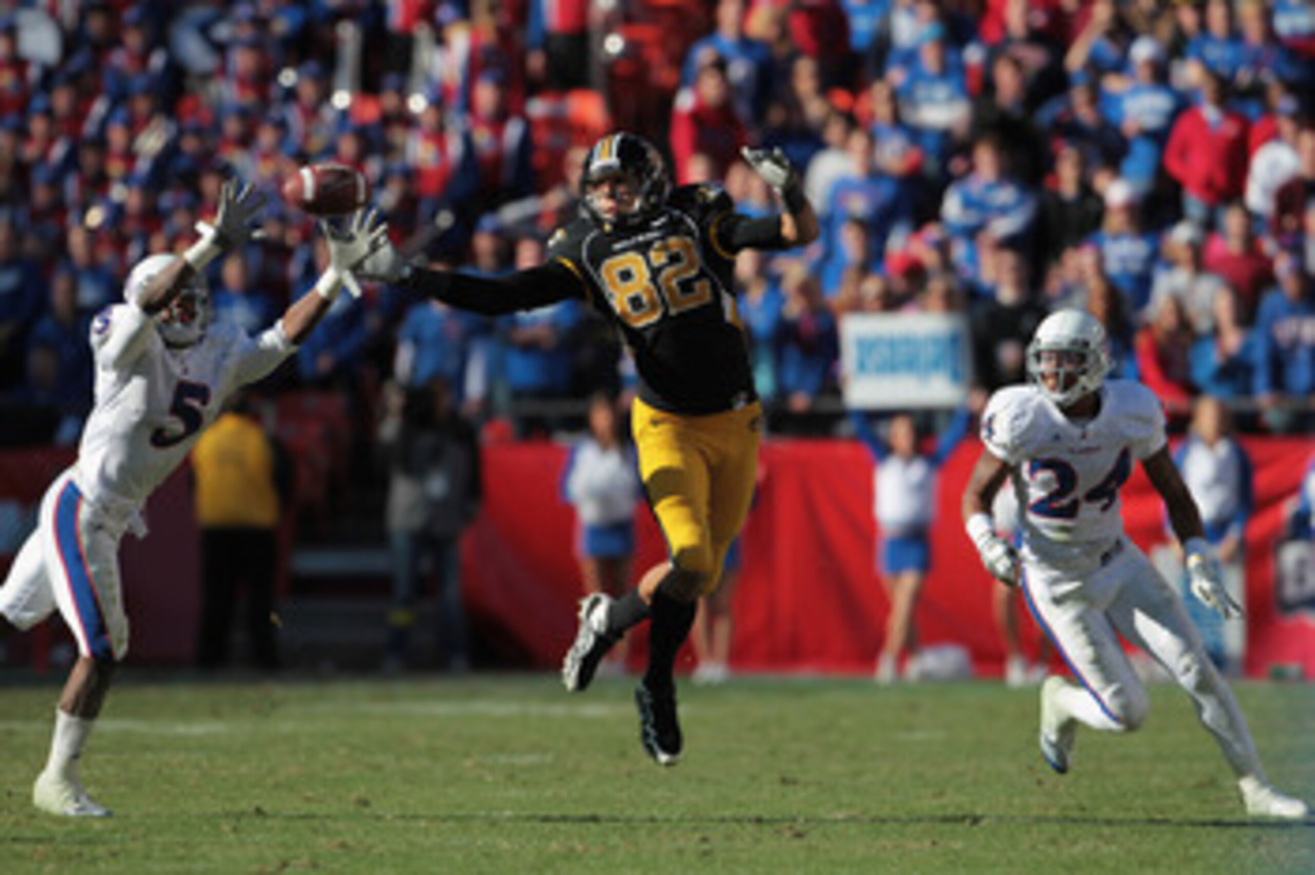KANSAS CITY, MO - NOVEMBER 27:  Cornerback Greg Brown #5 of the Kansas Jayhawks breaks up a pass intended for Michael Egnew #82 of the Missouri Tigers as Bradley McDougald #24 looks on during the game on November 27, 2010 at Arrowhead Stadium in Kansas Ci