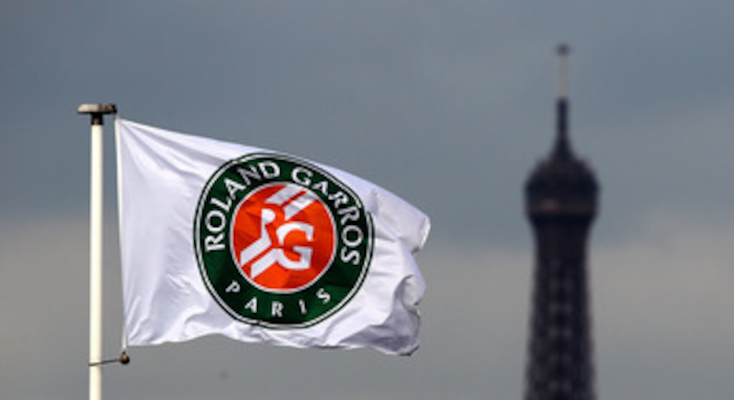 PARIS - MAY 26:  The Eiffel Tower is seen in the background of a flag on day four of the French Open at Roland Garros on May 26, 2010 in Paris, France.  (Photo by Clive Brunskill/Getty Images)