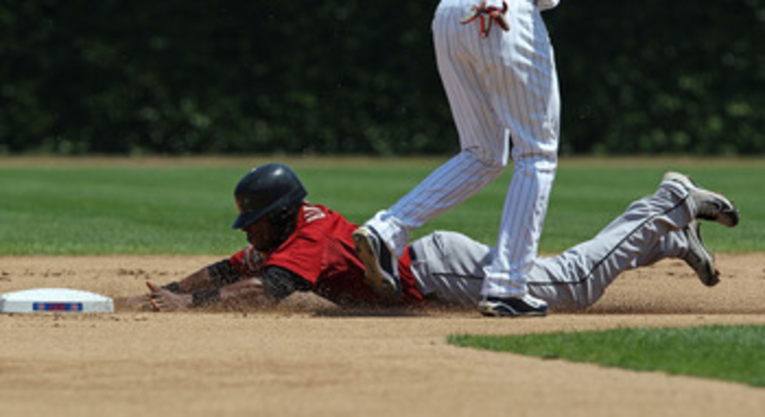 CHICAGO - JULY 21: Jason Bourgeois #11 of the Houston Astros dives into 2nd base with a steal  against the Chicago Cubs at Wrigley Field on July 21, 2010 in Chicago, Illinois. The Astros defeated the Cubs 4-3 in 12 innings. (Photo by Jonathan Daniel/Getty