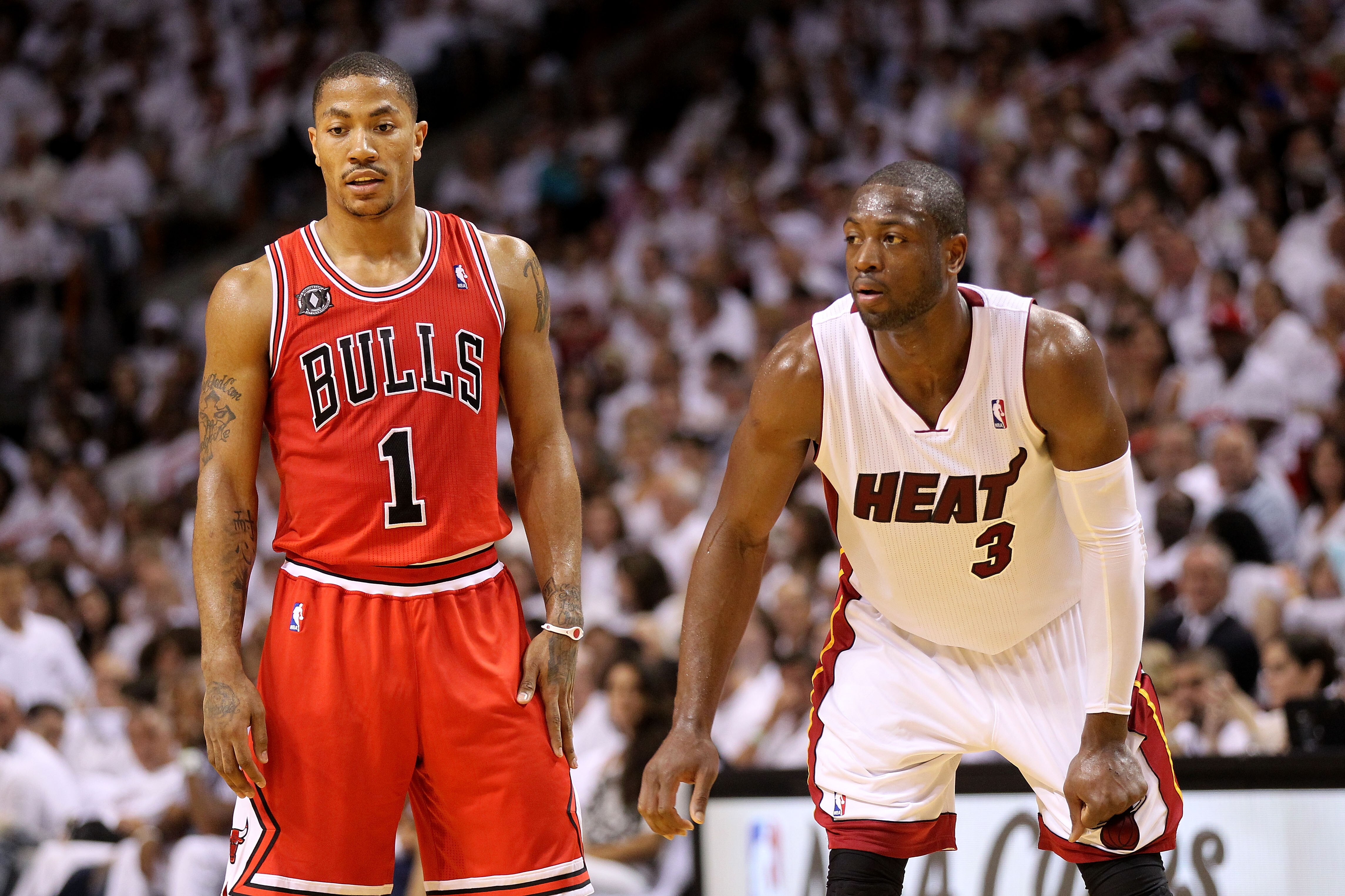 MIAMI, FL - MAY 22:  Derrick Rose #1 of the Chicago Bulls and Dwyane Wade #3 of the Miami Heat look on in Game Three of the Eastern Conference Finals during the 2011 NBA Playoffs on May 22, 2011 at American Airlines Arena in Miami, Florida.  NOTE TO USER: