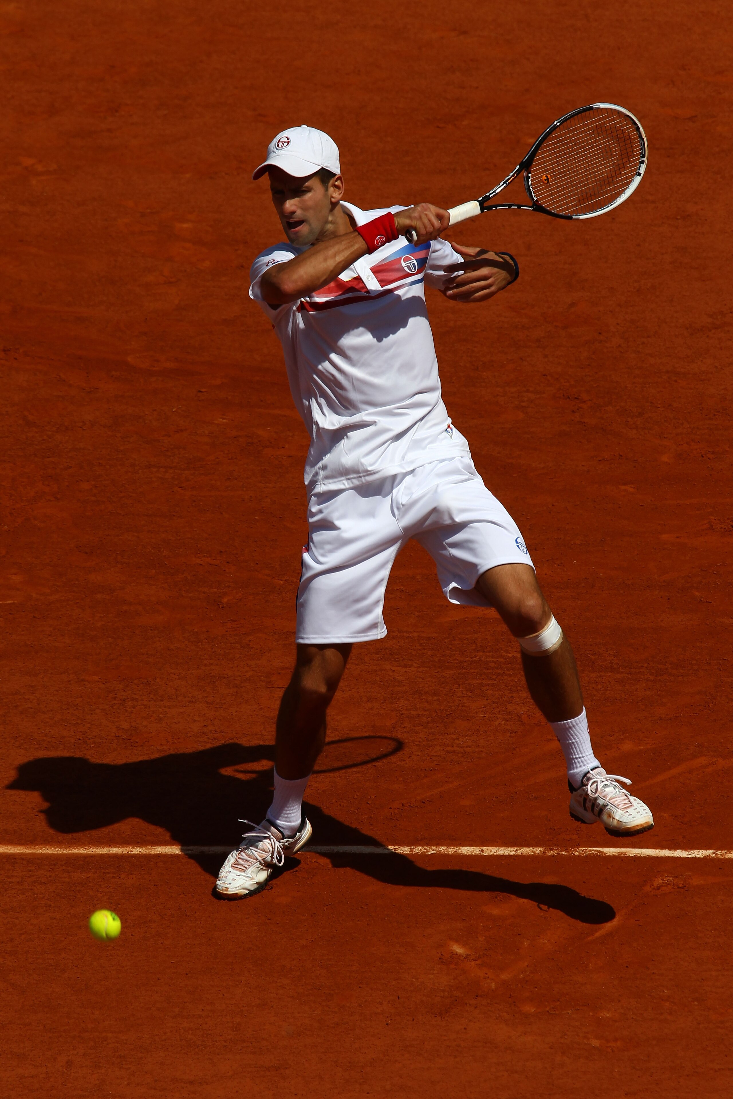 PARIS, FRANCE - MAY 23:  Novak Djokovic of Serbia hits a forehand during the men's singles first round match between Thiemo De Bakker of Netherlands and Novak Djokovic of Serbia on day two of the French Open at Roland Garros on May 23, 2011 in Paris, Fran