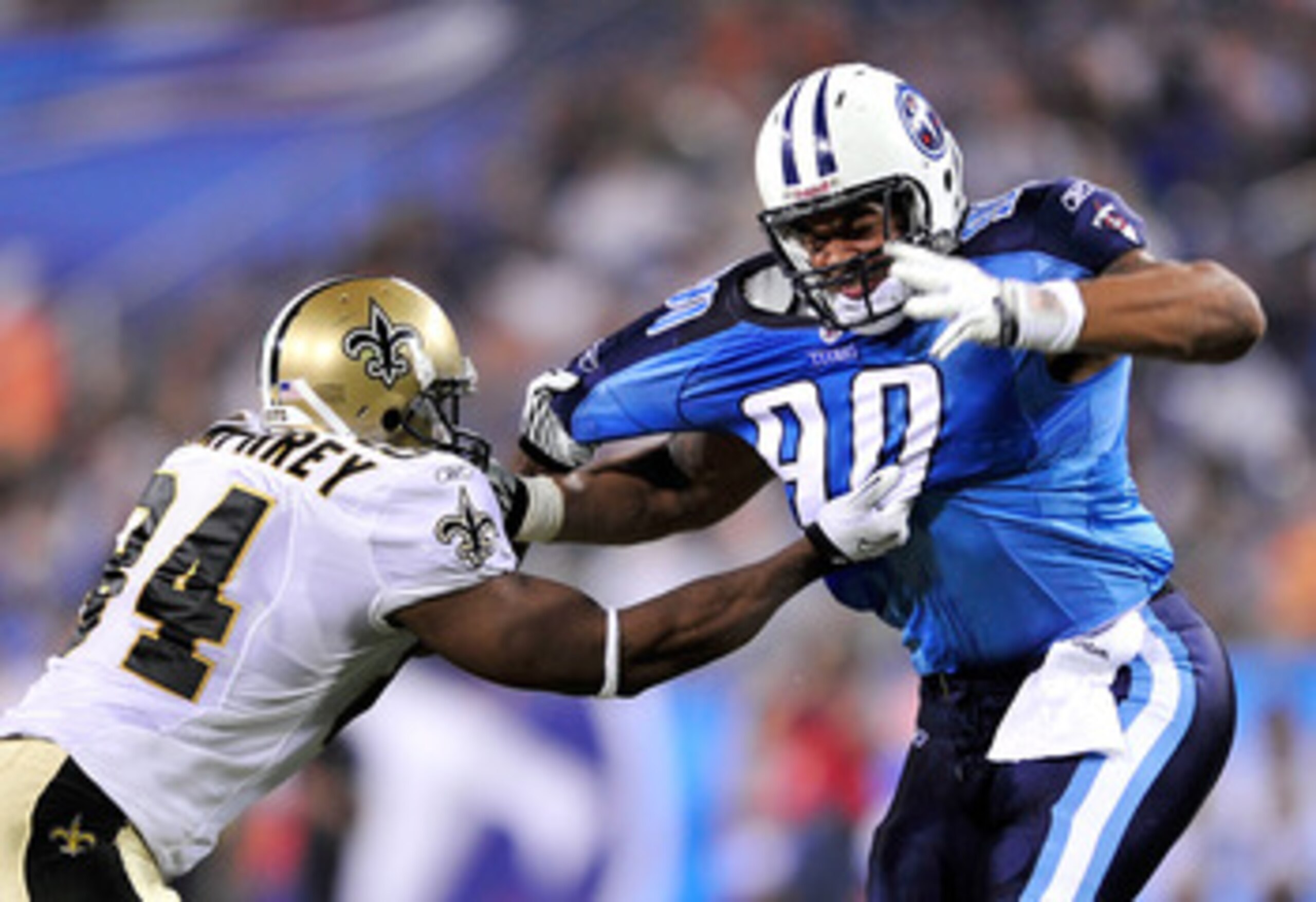 NASHVILLE, TN - SEPTEMBER 02:  Tory Humphrey #84 of the New Orleans Saints ties up Derrick Morgan #90 of the Tennessee Titans during the first half of an exhibition game at LP Field on September 2, 2010 in Nashville, Tennessee.  (Photo by Grant Halverson/