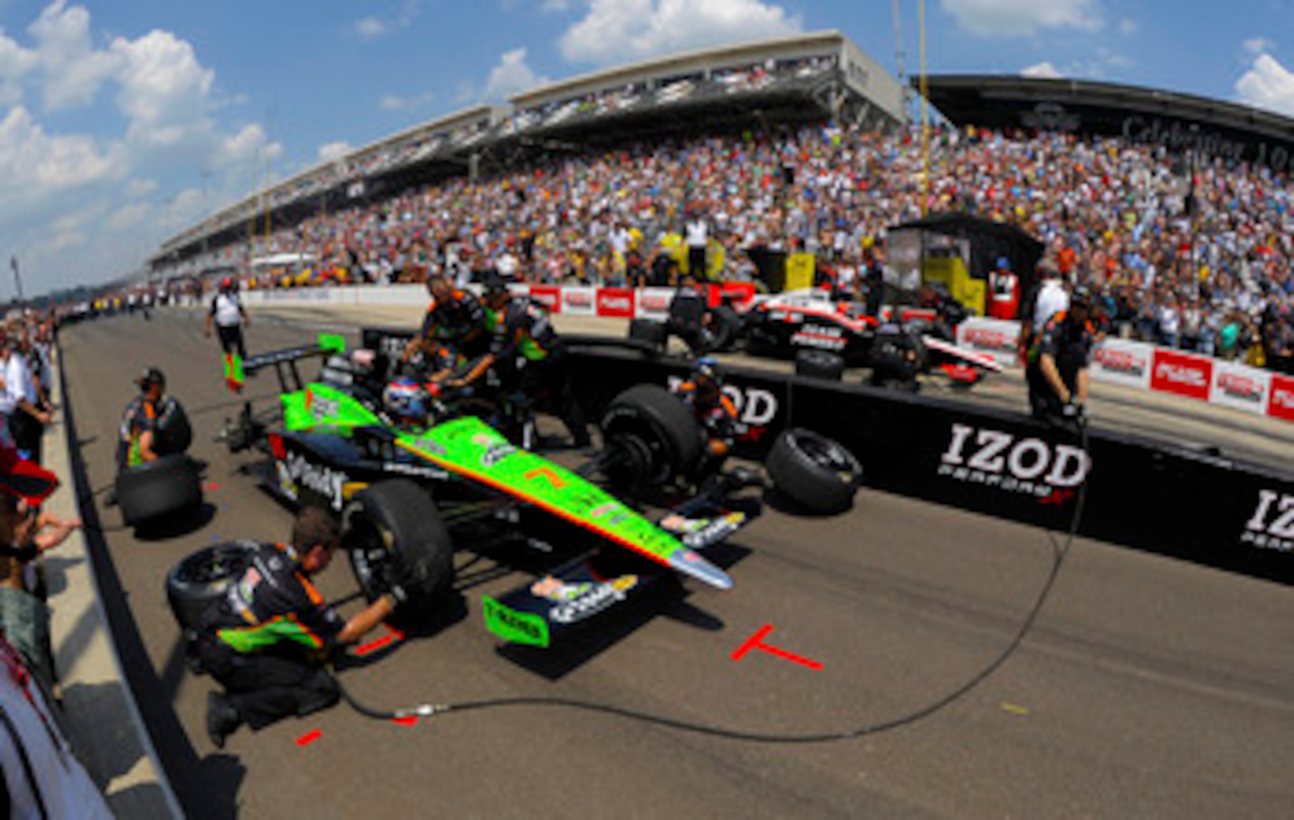 INDIANAPOLIS - MAY 28: The crew for Danica Patrick, driver of the #7 Team Godaddy.com Andretti Autosport Dallara Honda, work on her car during the pit stop challenge prior to the IZOD IndyCar Series 94th running of the Indianapolis 500 at the Indianapoli INDIANAPOLIS - MAY 28: The crew for Danica Patrick, driver of the #7 Team Godaddy.com Andretti Autosport Dallara Honda, work on her car during the pit stop challenge prior to the IZOD IndyCar Series 94th running of the Indianapolis 500 at the Indianapoli