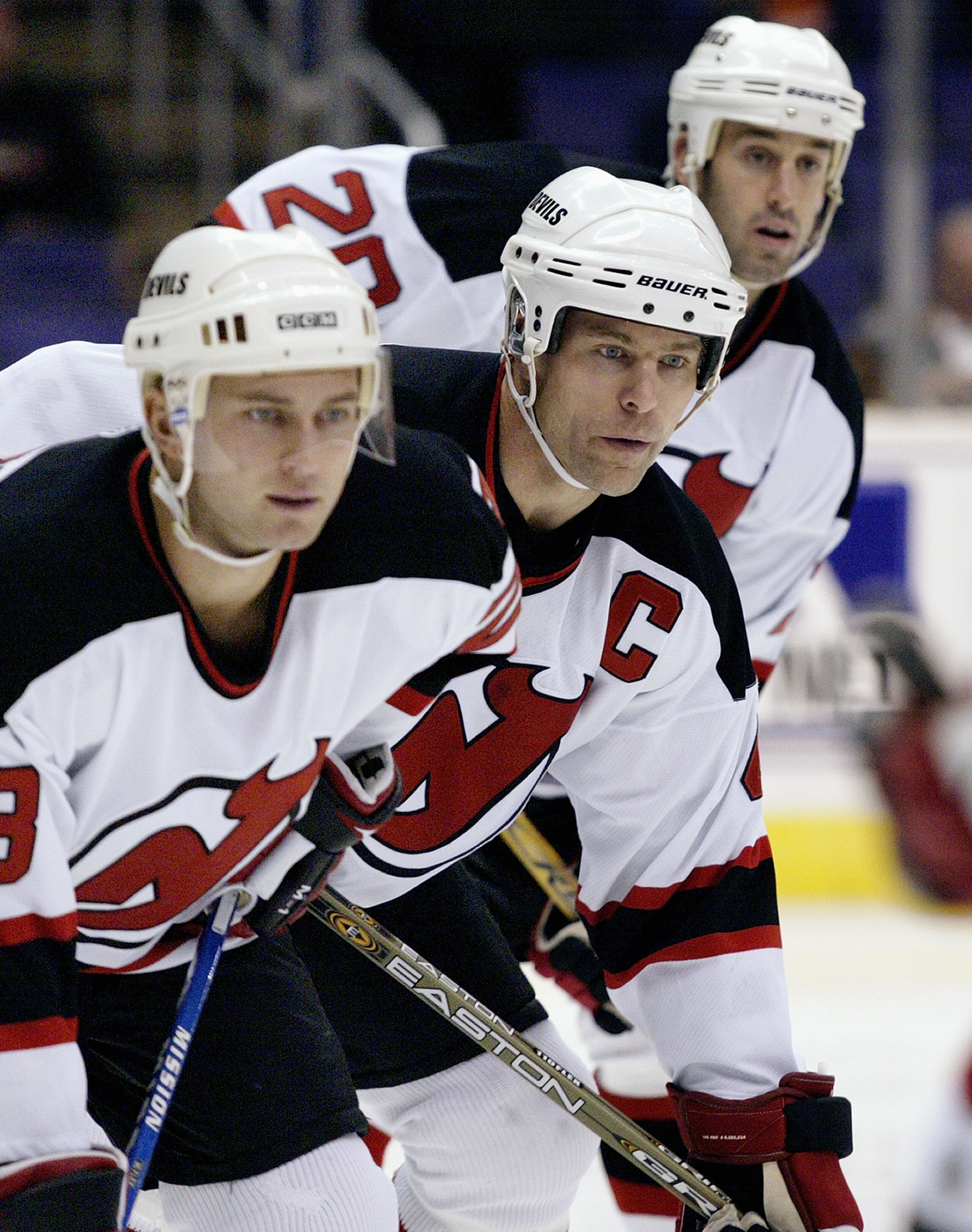 LOS ANGELES - NOVEMBER 25: Captain Scott Stevens #4 of the New Jersey Devils, center, lines up for a defensive zone faceoff against the Los Angeles Kings on November 25, 2003 at Staples Center in Los Angeles, California. The Devils defeated the Kings 3-0 LOS ANGELES - NOVEMBER 25: Captain Scott Stevens #4 of the New Jersey Devils, center, lines up for a defensive zone faceoff against the Los Angeles Kings on November 25, 2003 at Staples Center in Los Angeles, California. The Devils defeated the Kings 3-0