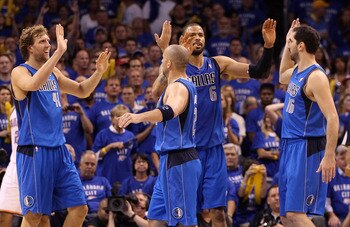 OKLAHOMA CITY, OK - MAY 23:  (L-R) Dirk Nowitzki #41, Jason Kidd #2, Tyson Chandler #6 and Peja Stojakovic #16 of the Dallas Mavericks react in the fourth quarter while taking on the Oklahoma City Thunder in Game Four of the Western Conference Finals duri