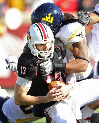 LOUISVILLE, KY - NOVEMBER 20:  Justin Burke #13 of the Louisville Cardinals is sacked by Bruce Irvin #11 of the West Virginia Mountaineers during the game at Papa John's Cardinal Stadium on November 20, 2010 in Louisville, Kentucky.  (Photo by Andy Lyons/