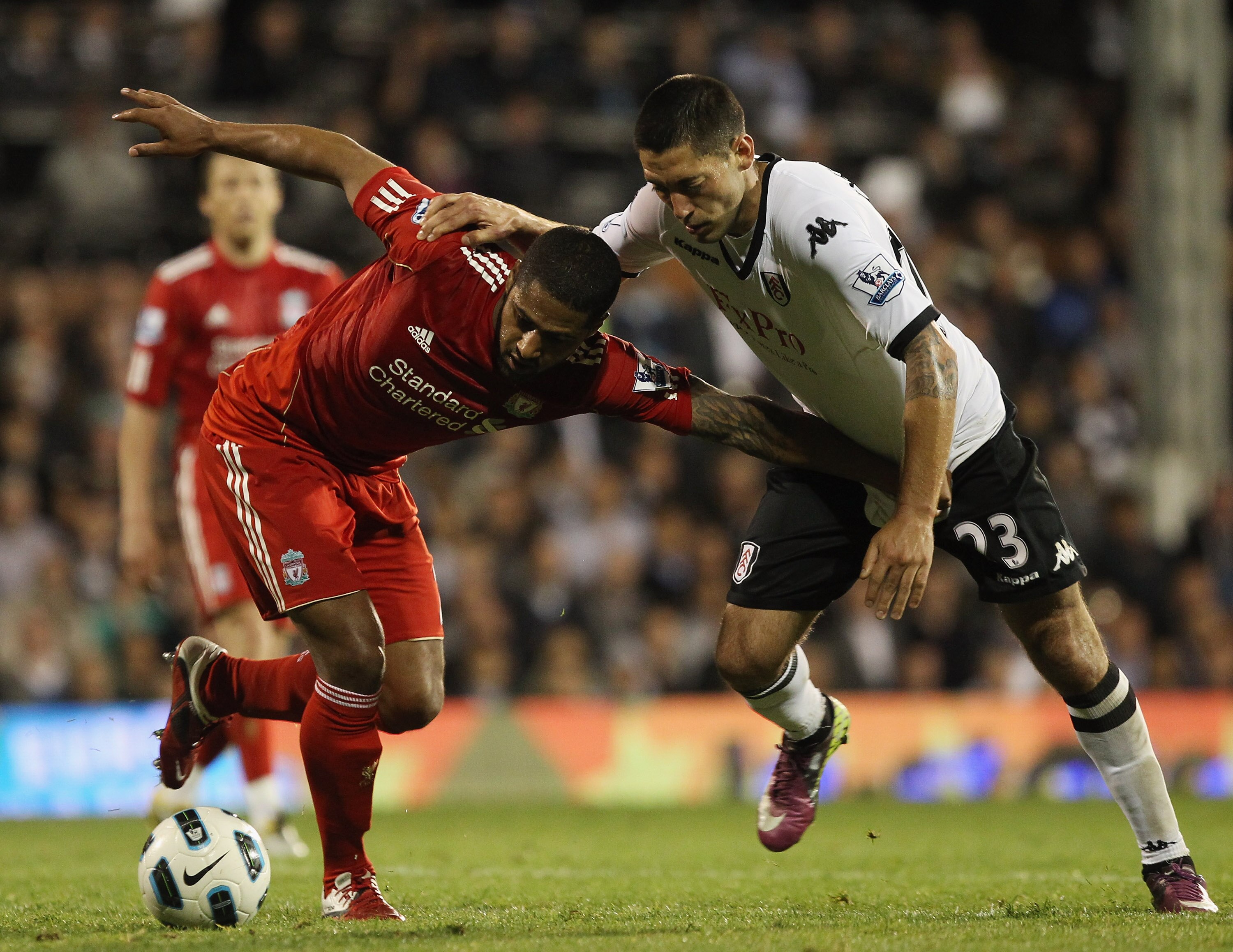 LONDON, ENGLAND - MAY 09:  Glen Johnson of Liverpool fights for the ball with Clint Dempsey of Fulham during the Barclays Premier League match between Fulham and Liverpool at Craven Cottage on May 9, 2011 in London, England.  (Photo by Scott Heavey/Getty