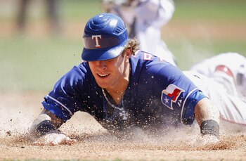 DETROIT, MI - APRIL 12: Josh Hamilton #32 of the Texas Rangers slides into home plate during the third inning while playing the Detroit Tigers at Comerica Park on April 12, 2011 in Detroit, Michigan. Hamilton was out from a tag by Victor Martinez (Photo DETROIT, MI - APRIL 12: Josh Hamilton #32 of the Texas Rangers slides into home plate during the third inning while playing the Detroit Tigers at Comerica Park on April 12, 2011 in Detroit, Michigan. Hamilton was out from a tag by Victor Martinez (Photo
