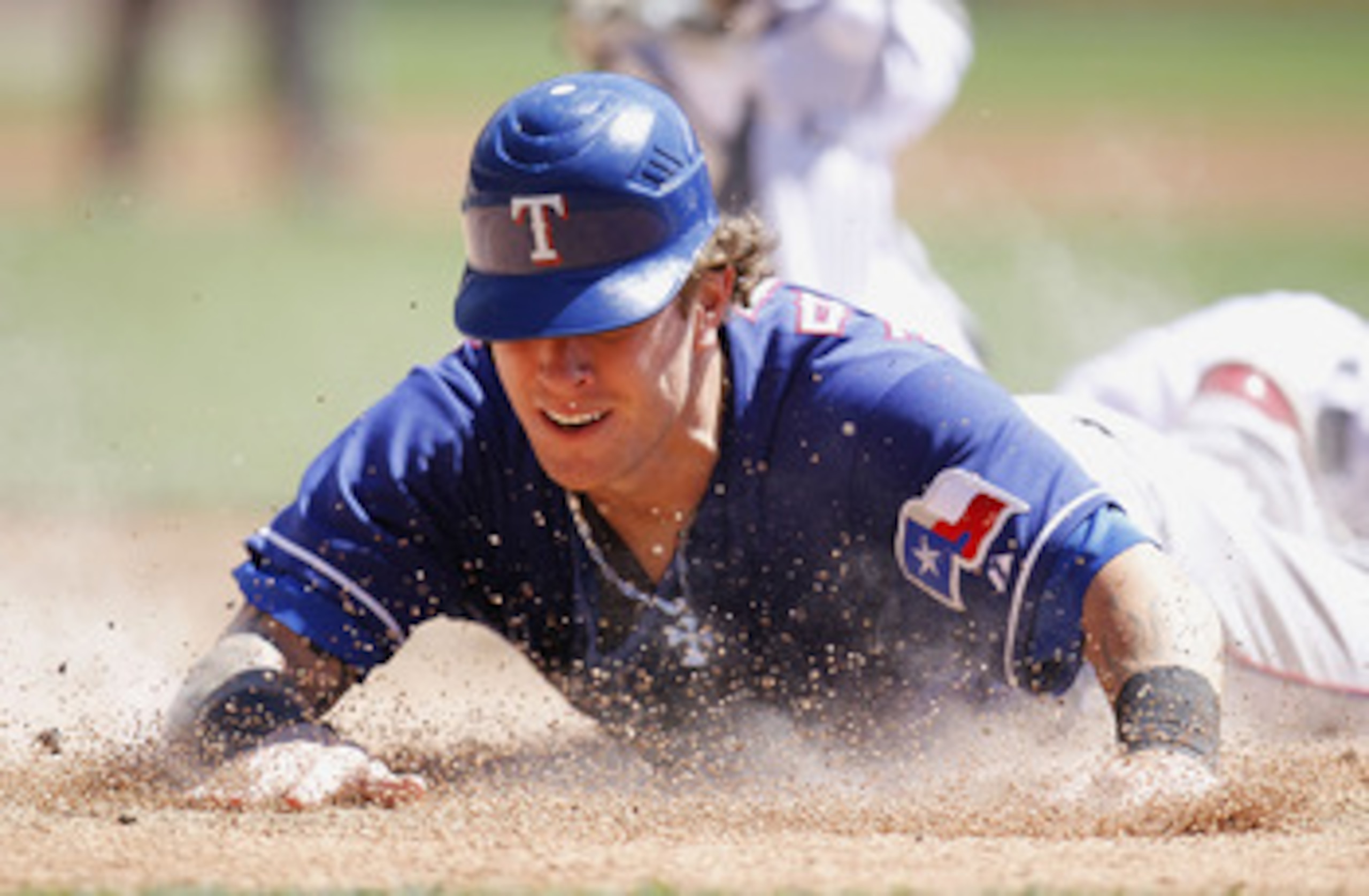 DETROIT, MI - APRIL 12:  Josh Hamilton #32 of the Texas Rangers slides into home plate during the third inning while playing the Detroit Tigers at Comerica Park on April 12, 2011 in Detroit, Michigan. Hamilton was out from a tag by Victor Martinez  (Photo