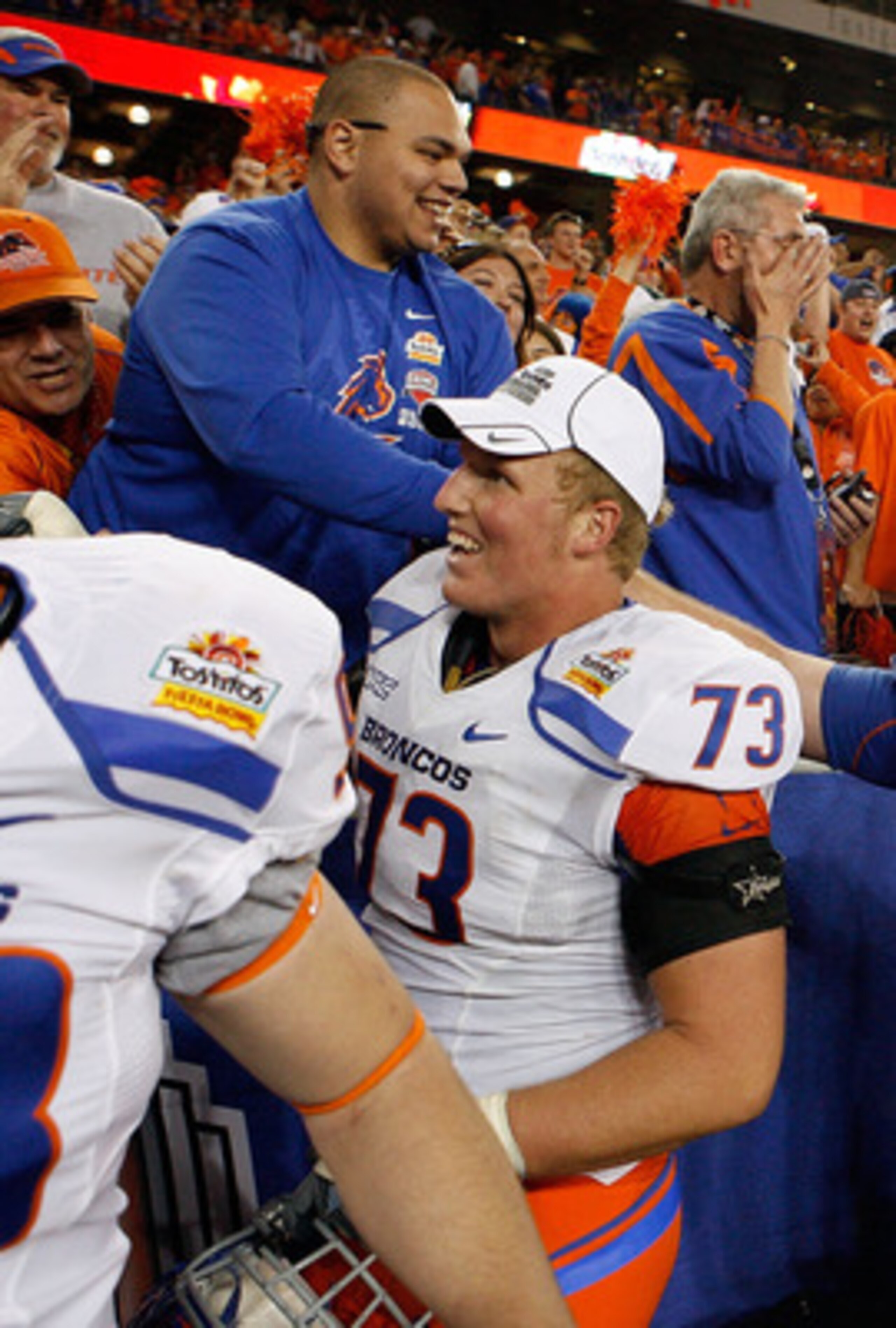 GLENDALE, AZ - JANUARY 04:  Nate Potter #73, Joe Kellogg #61 and Tommy Gallarda #85 of the Boise State Broncos and other teammates shake hands with their fans after their 17-10 victory against the TCU Horned Frogs during the Tostitos Fiesta Bowl at the Un