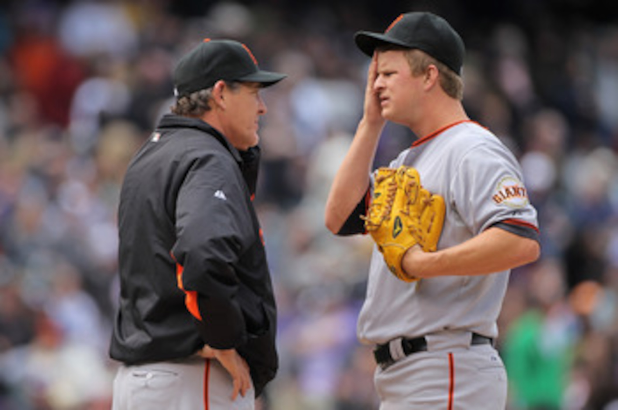 DENVER, CO - APRIL 20:  Pitching coach Dave Righetti (L) visiting mound to talk with starting pitcher Matt Cain #18 of the San Francisco Giants as he faces the Colorado Rockies at Coors Field on April 20, 2011 in Denver, Colorado.  (Photo by Doug Pensinge