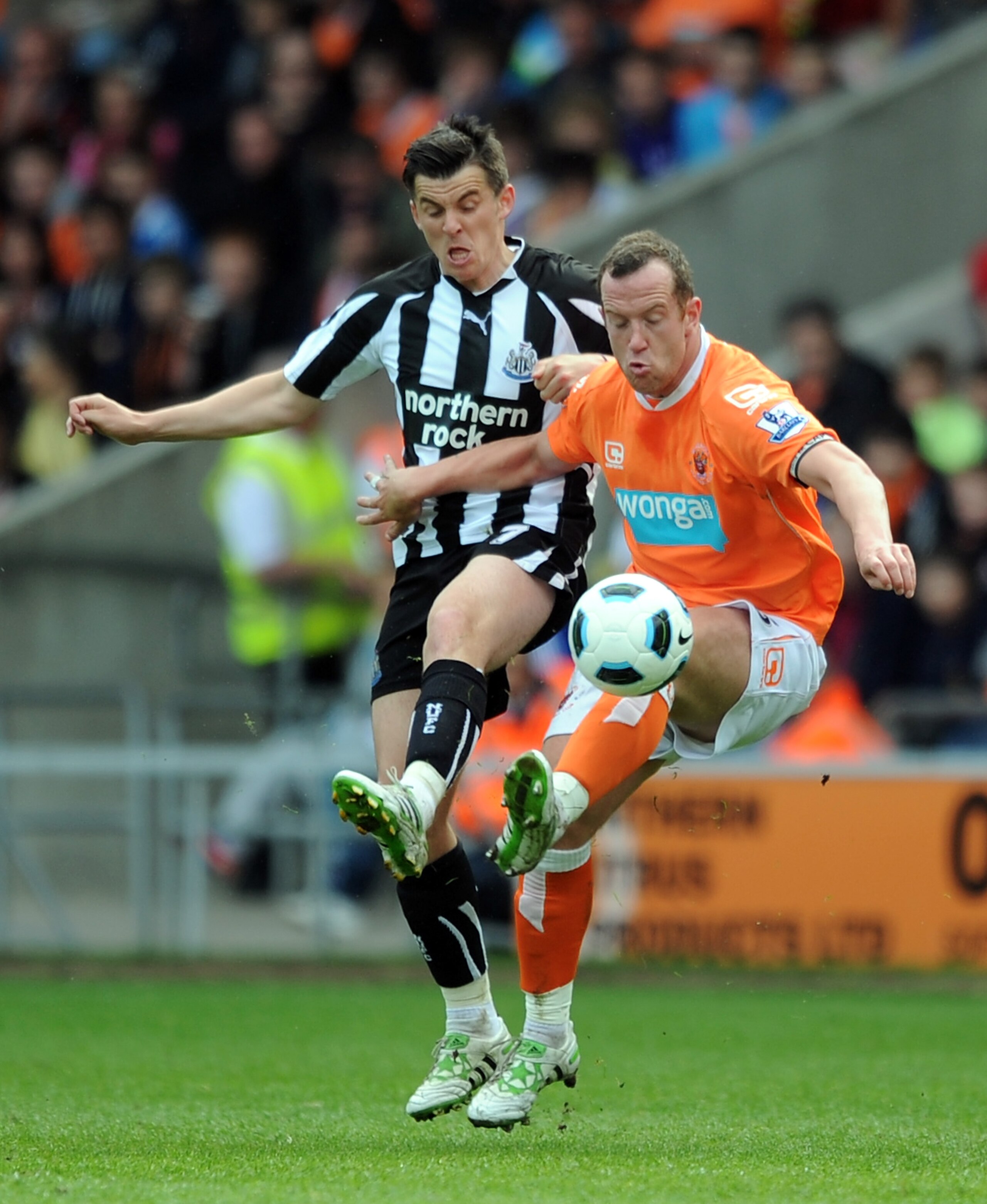 BLACKPOOL, ENGLAND - APRIL 23: Charlie Adam of Blackpool competes with Joey Barton of Newcastle United during the Barclays Premier League match between Blackpool and Newcastle United at Bloomfield Road on April 23, 2011 in Blackpool, England.  (Photo by C