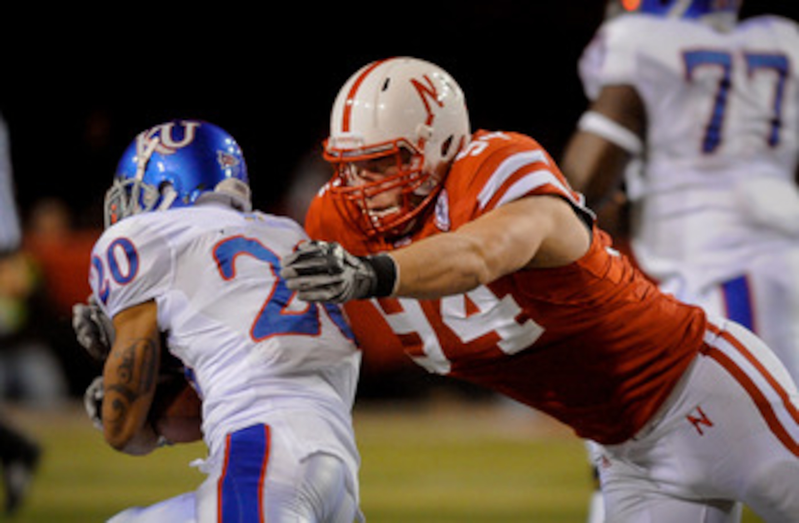 LINCOLN, NE - NOVEMBER 13: Jared Crick #94 of the Nebraska Cornhuskers runs down D.J. Beshears #20 of the Kansas Jayhawks during first half action of their game at Memorial Stadium on November 13, 2010 in Lincoln, Nebraska.  (Photo by Eric Francis/Getty I
