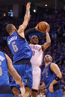 OKLAHOMA CITY, OK - MAY 23:  Russell Westbrook #0 of the Oklahoma City Thunder looks to shoot between Tyson Chandler #6 and Jason Kidd #2 of the Dallas Mavericks in the second half in Game Four of the Western Conference Finals during the 2011 NBA Playoffs