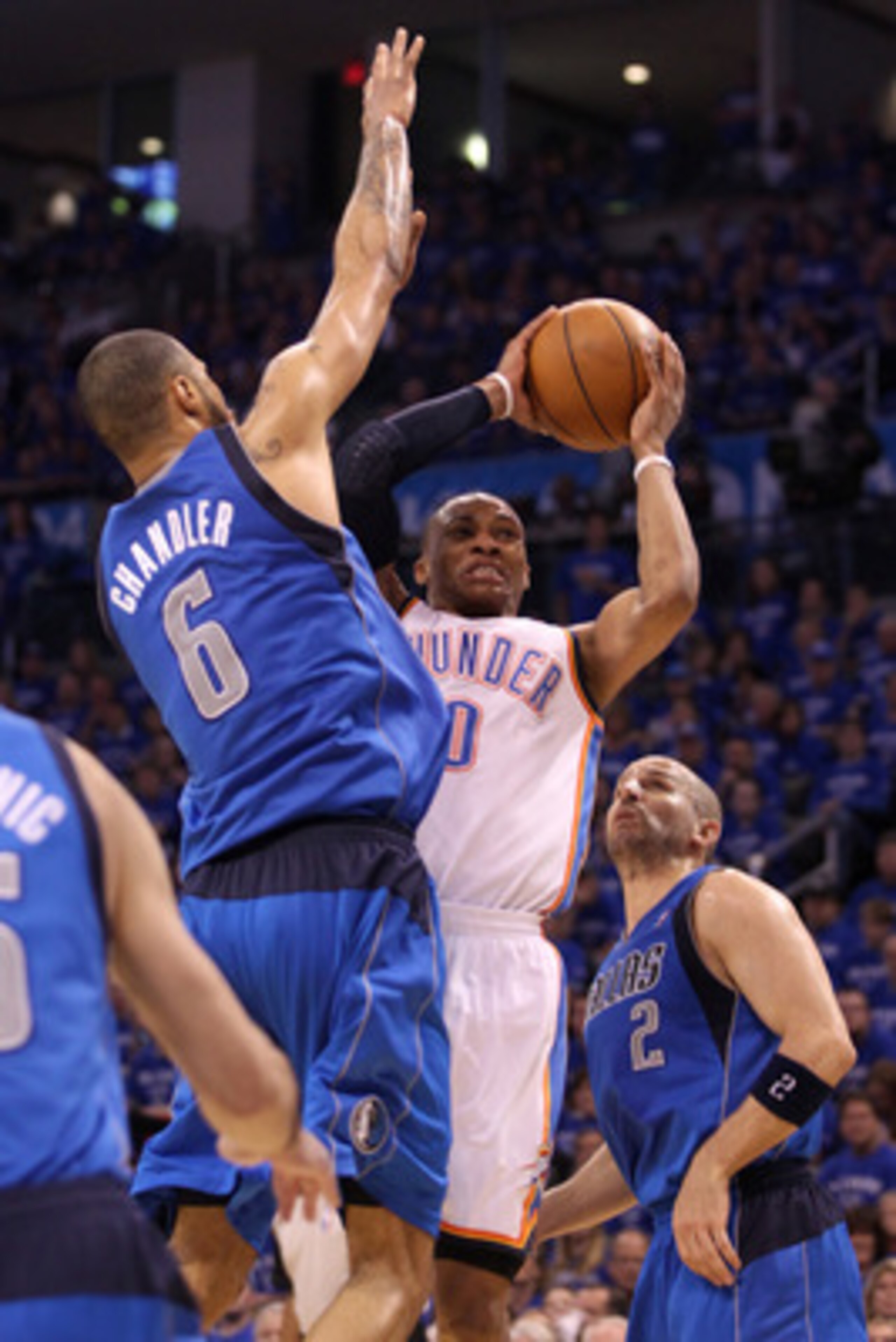 OKLAHOMA CITY, OK - MAY 23:  Russell Westbrook #0 of the Oklahoma City Thunder looks to shoot between Tyson Chandler #6 and Jason Kidd #2 of the Dallas Mavericks in the second half in Game Four of the Western Conference Finals during the 2011 NBA Playoffs