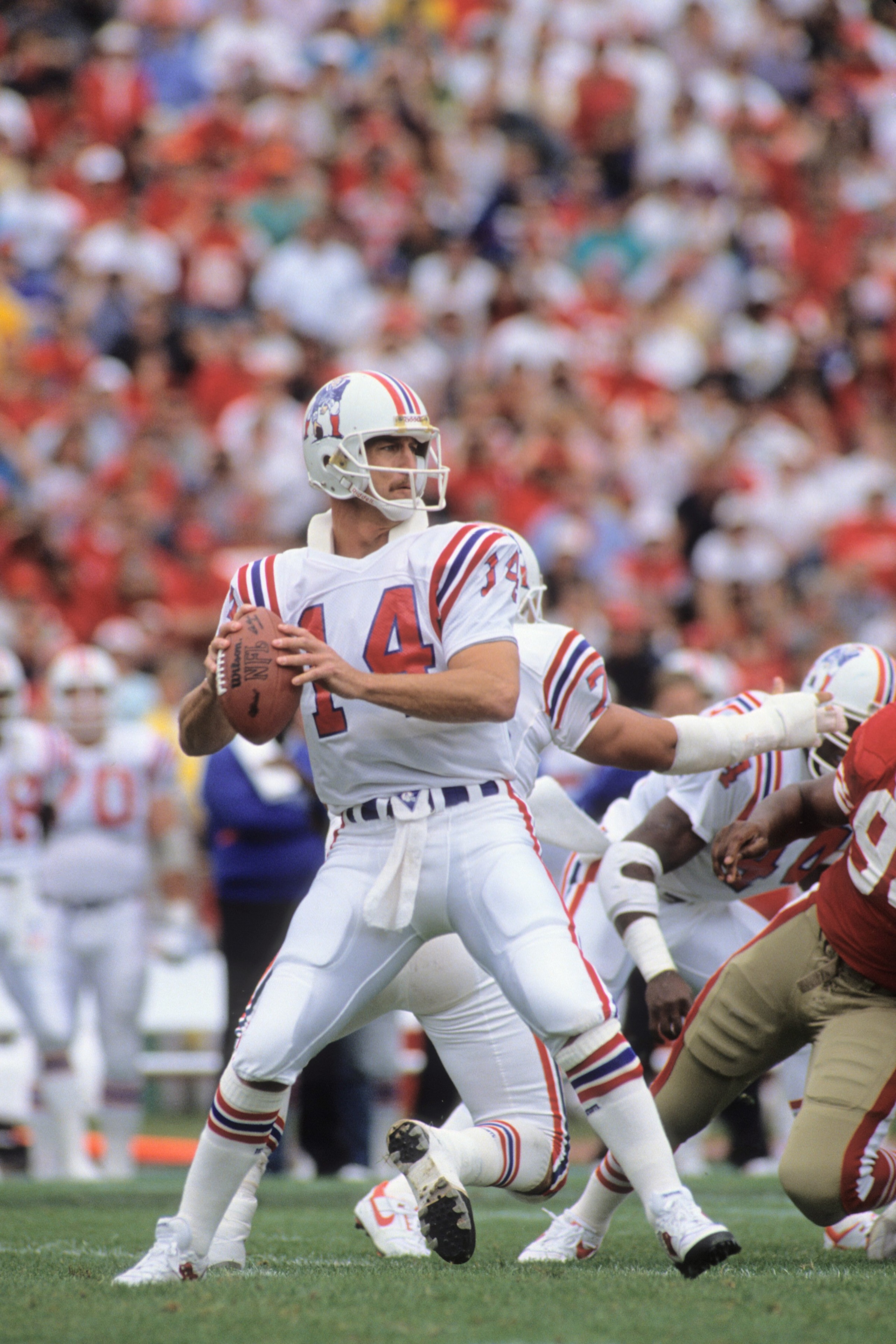 SAN FRANCISCO, CA - OCTOBER 22:  Quarterback Steve Grogan #14 of New England Patriots drops back to pass during the game against the San Francisco 49ers at Candlestick Park on October 22, 1989 in San Francisco, California.  The 49ers won 37-20.  (Photo by