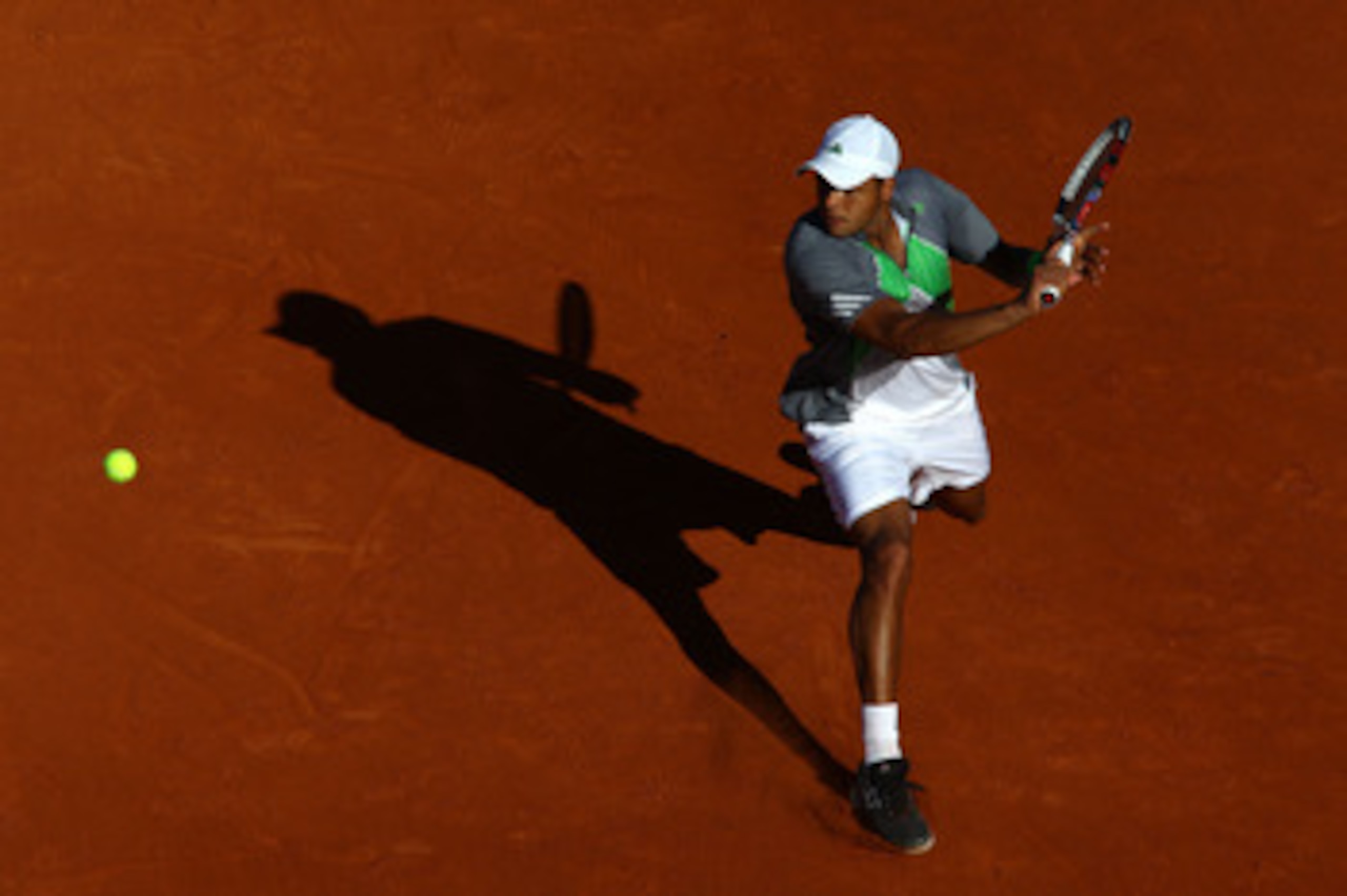 PARIS, FRANCE - MAY 25:  Jo-Wilfried Tsonga of France hits a backhand during the men's singles round two match between Igor Andreev of Russia and Jo-Wilfried Tsonga of France on day four of the French Open at Roland Garros on May 25, 2011 in Paris, France