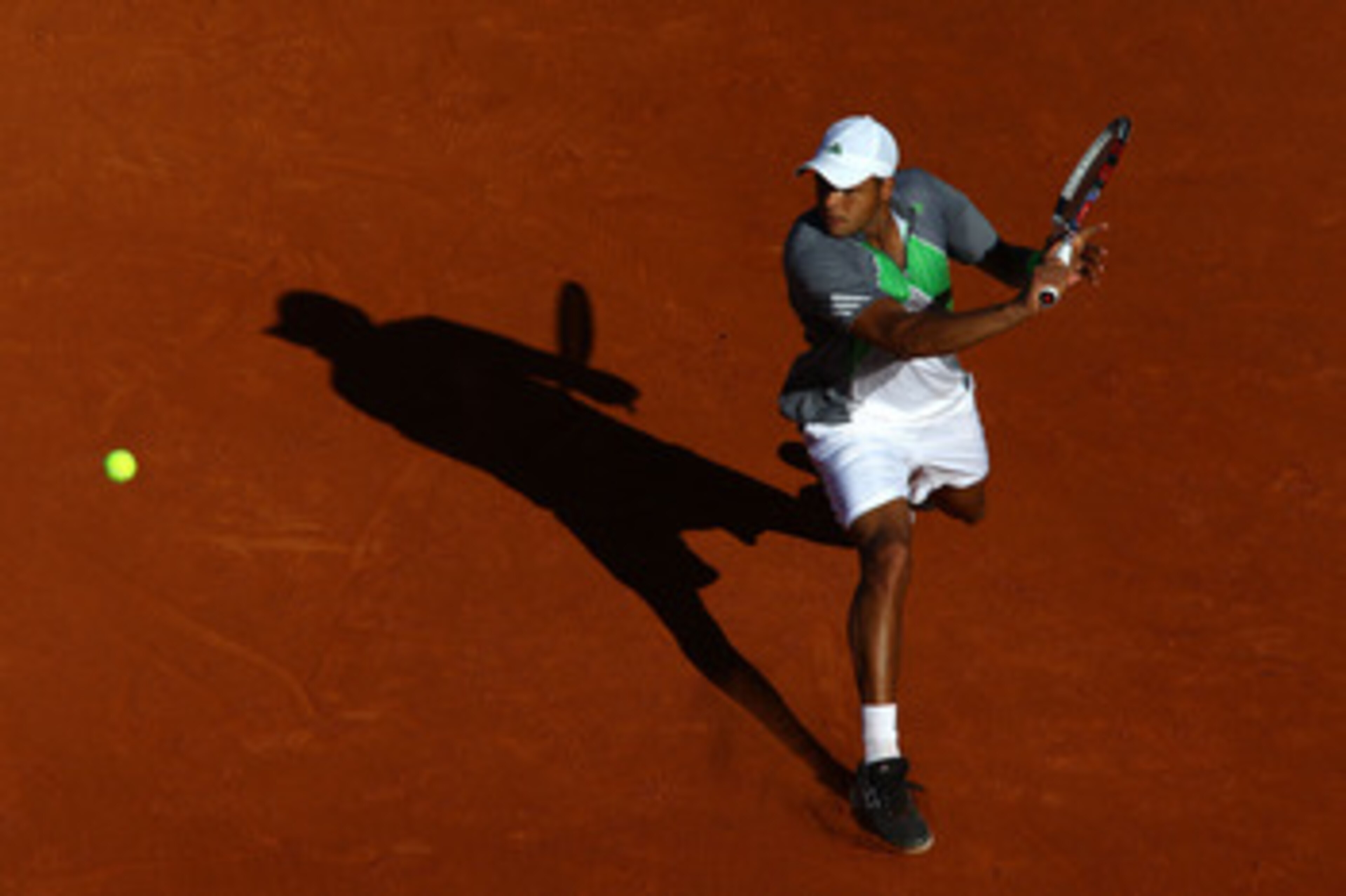 PARIS, FRANCE - MAY 25:  Jo-Wilfried Tsonga of France hits a backhand during the men's singles round two match between Igor Andreev of Russia and Jo-Wilfried Tsonga of France on day four of the French Open at Roland Garros on May 25, 2011 in Paris, France