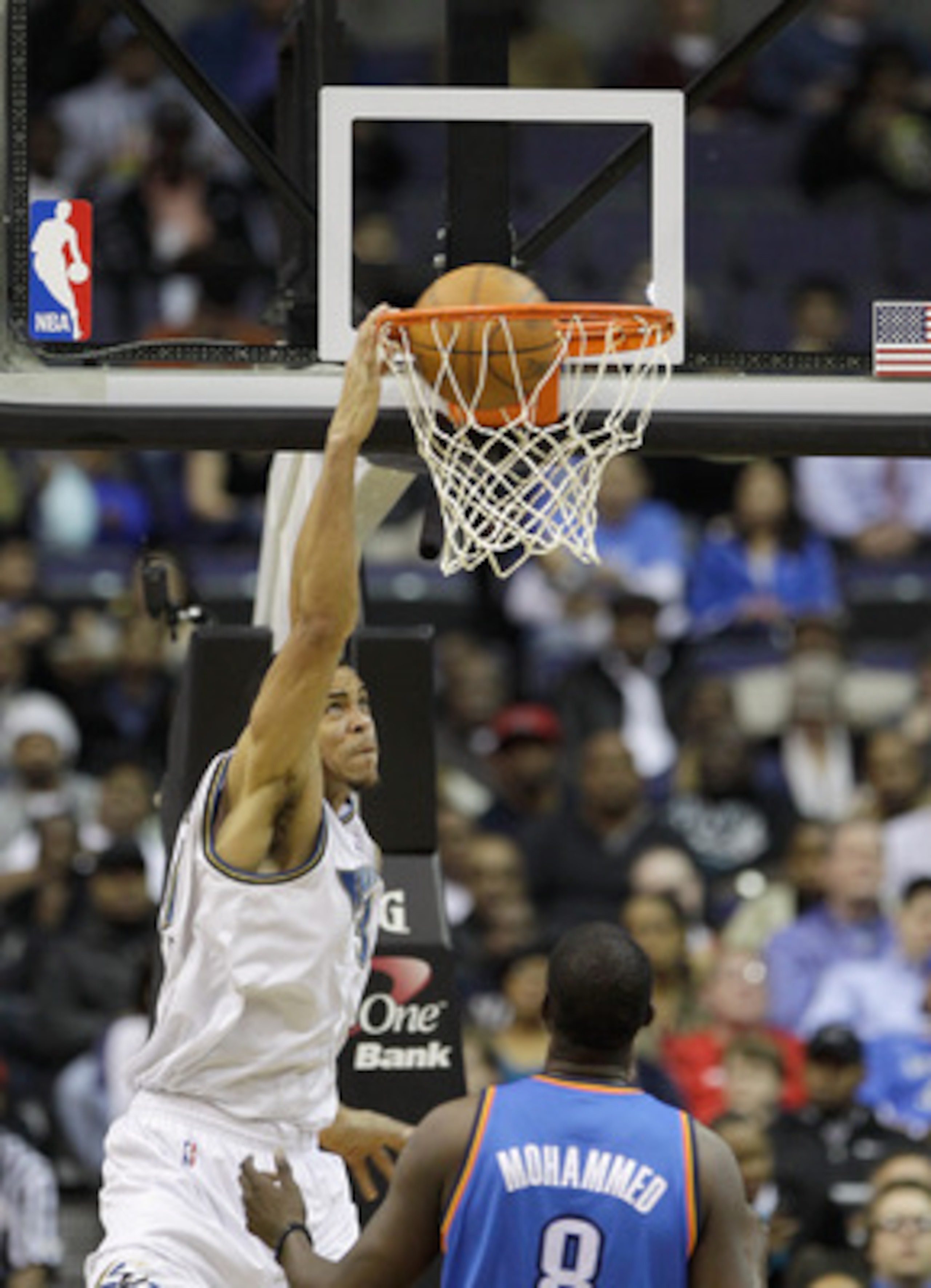WASHINGTON, DC - MARCH 14:  JaVale McGee #34 of the Washington Wizards dunks against Nazr Mohammed #8 of the Oklahoma City ThundeOklahoma City Thunderduring the first half at the Verizon Center on March 14, 2011 in Washington, DC. NOTE TO USER: User expre