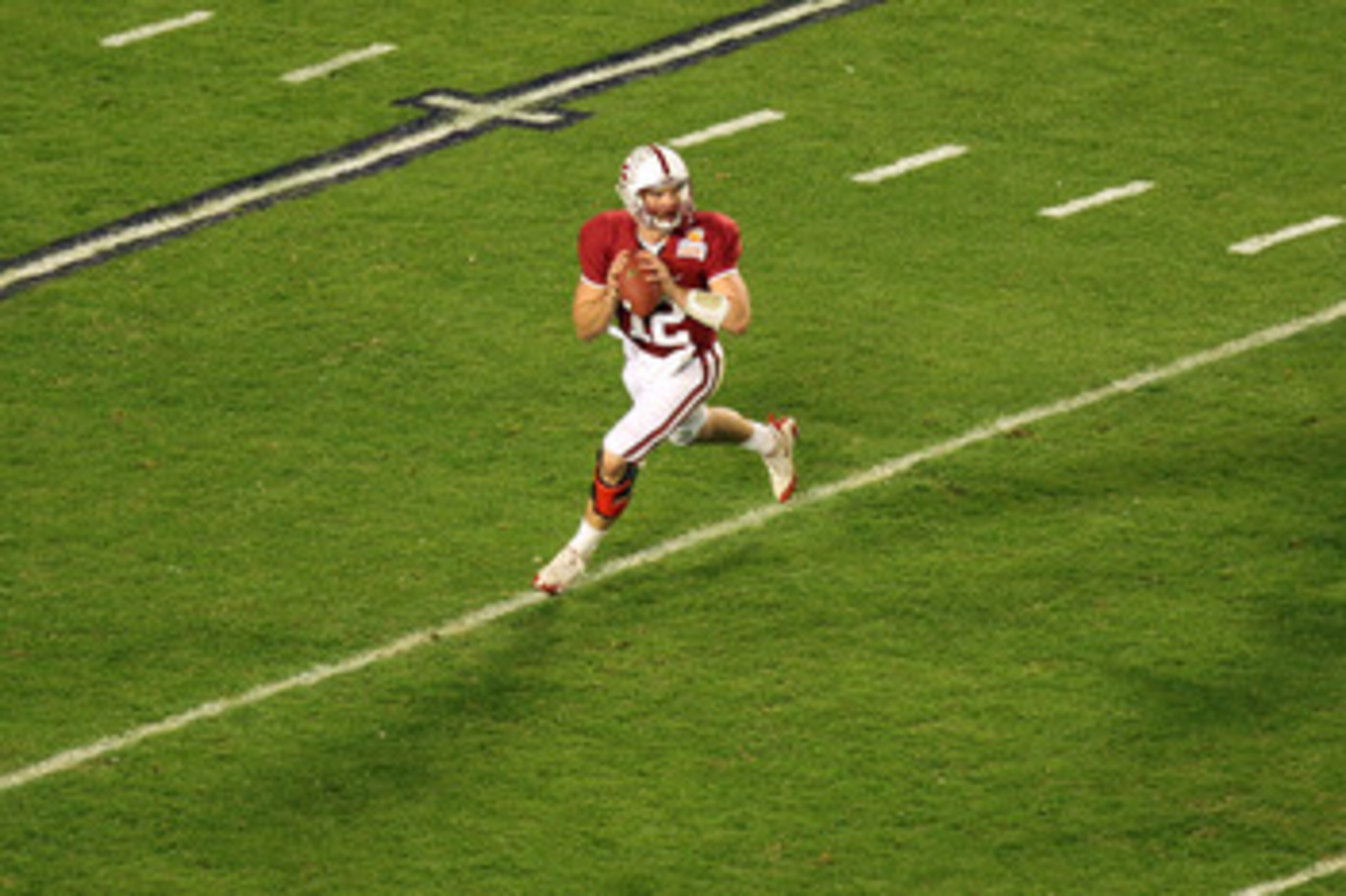 MIAMI, FL - JANUARY 03:  Quarterback Andrew Luck #12 of the Stanford Cardinal looks to pass as he rolls out of the pocket against the Virginia Tech Hokies during the 2011 Discover Orange Bowl at Sun Life Stadium on January 3, 2011 in Miami, Florida. Stanf