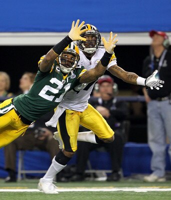 ARLINGTON, TX - FEBRUARY 06:  Charles Woodson #21 of the Green Bay Packers is injured as he attempts to break up a pass intended for Mike Wallace #17 of the Pittsburgh Steelers during Super Bowl XLV at Cowboys Stadium on February 6, 2011 in Arlington, Tex