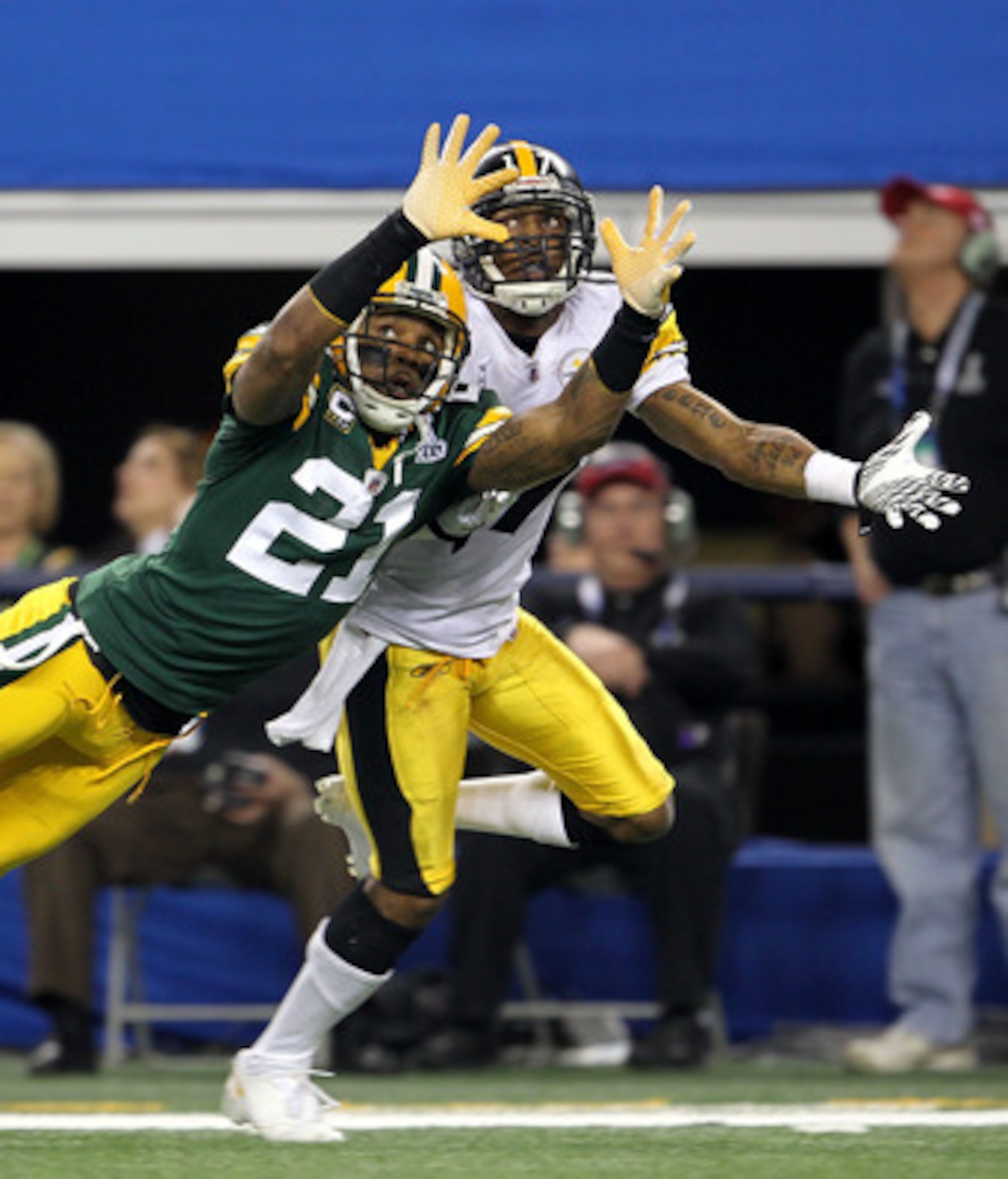 ARLINGTON, TX - FEBRUARY 06:  Charles Woodson #21 of the Green Bay Packers is injured as he attempts to break up a pass intended for Mike Wallace #17 of the Pittsburgh Steelers during Super Bowl XLV at Cowboys Stadium on February 6, 2011 in Arlington, Tex