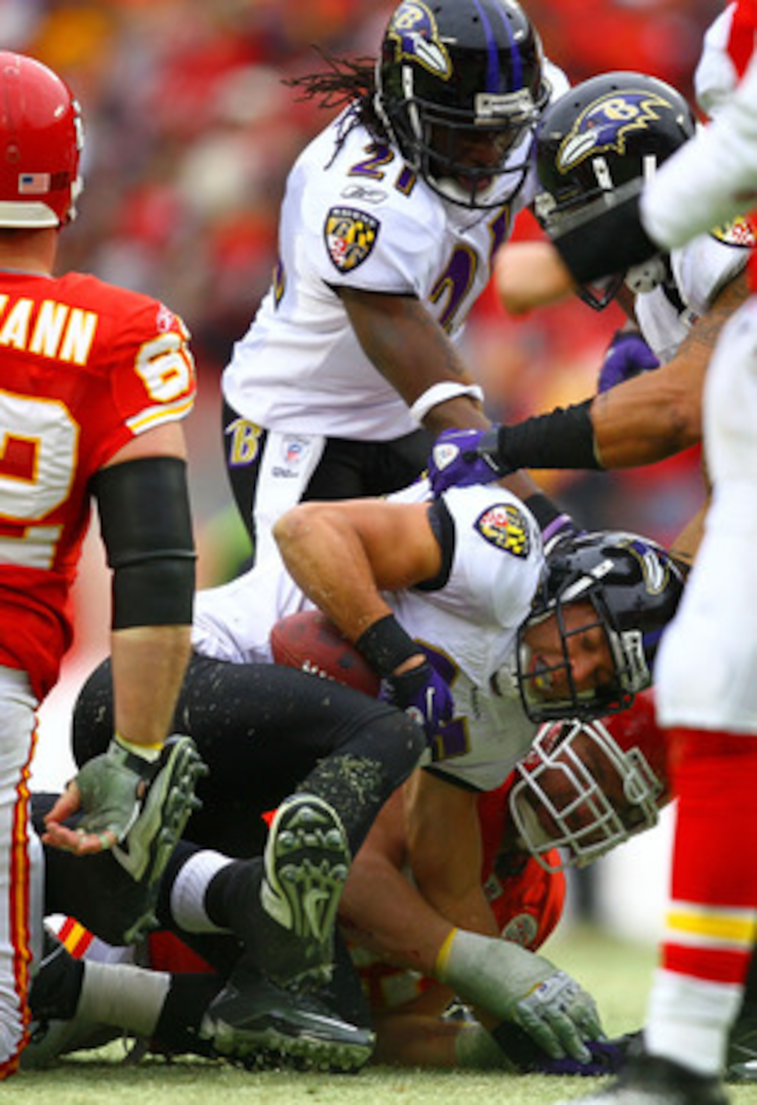 KANSAS CITY, MO - JANUARY 09:  Cornerback Chris Carr #25 of the Baltimore Ravens recovers a fumble by the Kansas City Chiefs during their 2011 AFC wild card playoff game at Arrowhead Stadium on January 9, 2011 in Kansas City, Missouri.  (Photo by Dilip Vi