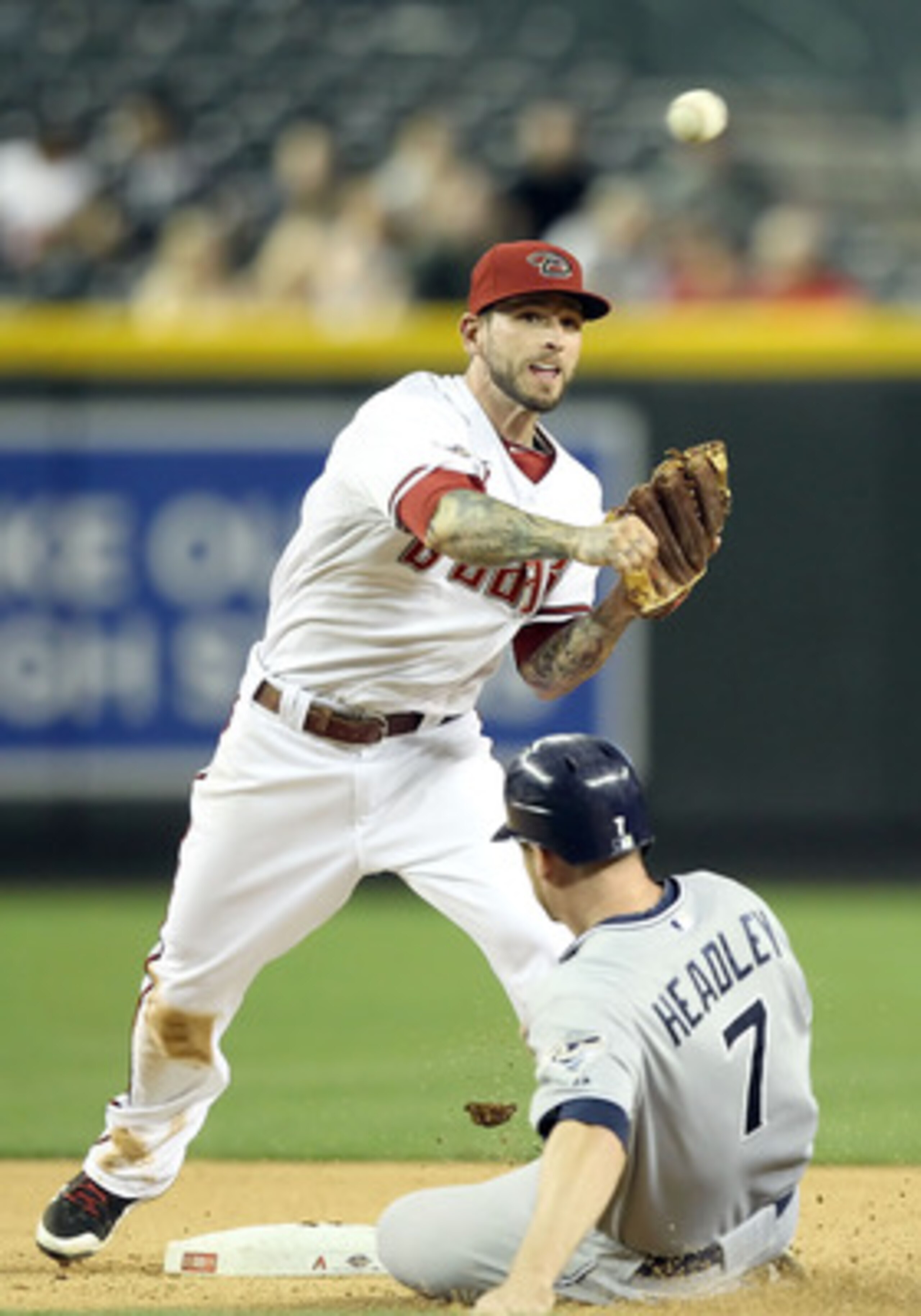PHOENIX, AZ - MAY 16: Infielder Ryan Roberts #14 of the Arizona Diamondbacks throws over the sliding Chase Headley #7 of the San Diego Padres attempting a double play during the seventh inning of the Major League Baseball game at Chase Field on May 16, 2 PHOENIX, AZ - MAY 16: Infielder Ryan Roberts #14 of the Arizona Diamondbacks throws over the sliding Chase Headley #7 of the San Diego Padres attempting a double play during the seventh inning of the Major League Baseball game at Chase Field on May 16, 2