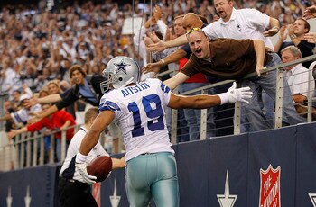 ARLINGTON, TX - NOVEMBER 21:  Miles Austin #19 of the Dallas Cowboys scores a third quarter touchdown on a 3 yard pass from Jon Kitna #3 and celebrates with the fans during the game at Dallas Stadium on November 21, 2010 in Arlington, Texas. The Cowboys d