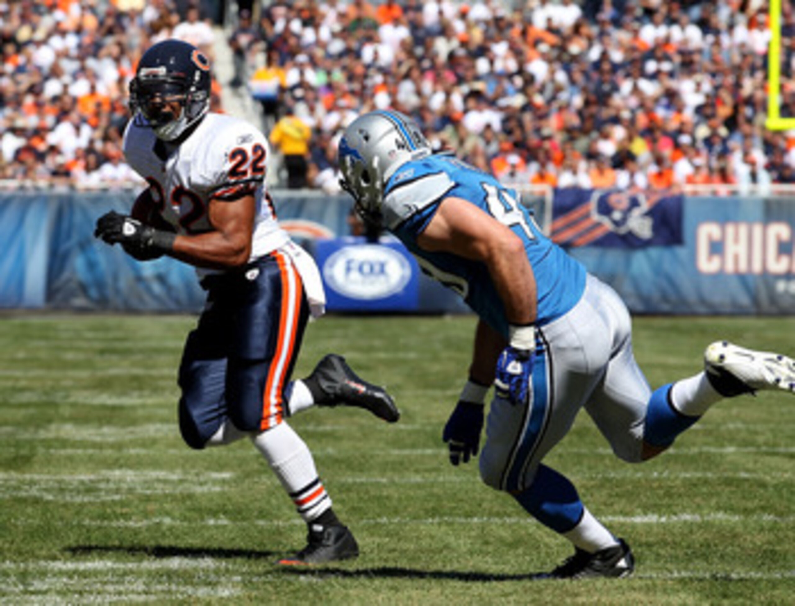 CHICAGO - SEPTEMBER 12: Matt Forte #22 of the Chicago Bears is pursued by Zack Follett #49 of the Detroit Lions during the NFL season opening game at Soldier Field on September 12, 2010 in Chicago, Illinois. The Bears defeated the Lions 19-14. (Photo by J