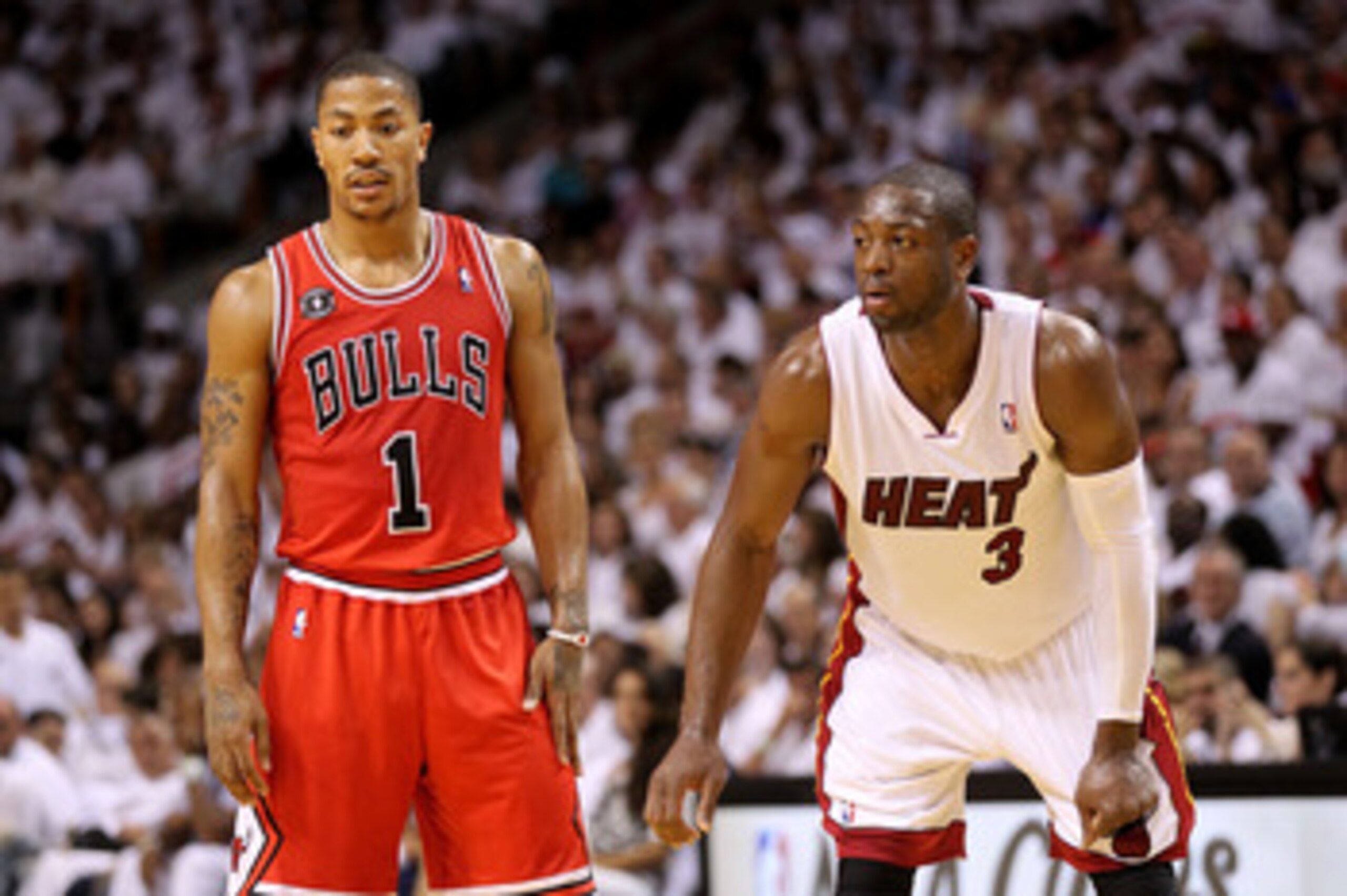 MIAMI, FL - MAY 22:  Derrick Rose #1 of the Chicago Bulls and Dwyane Wade #3 of the Miami Heat look on in Game Three of the Eastern Conference Finals during the 2011 NBA Playoffs on May 22, 2011 at American Airlines Arena in Miami, Florida.  NOTE TO USER: